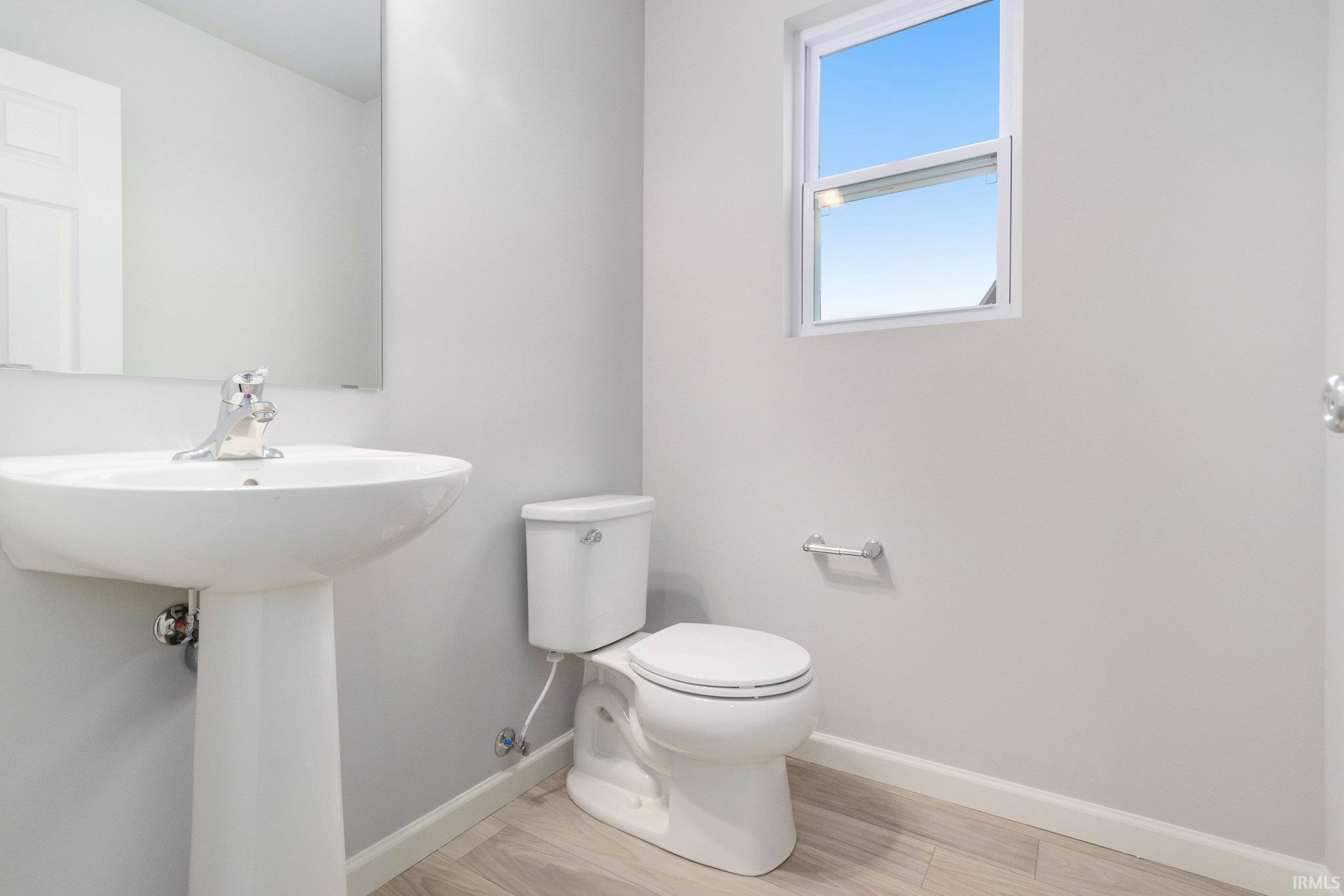 The powder room is located toward the front of the home for privacy.