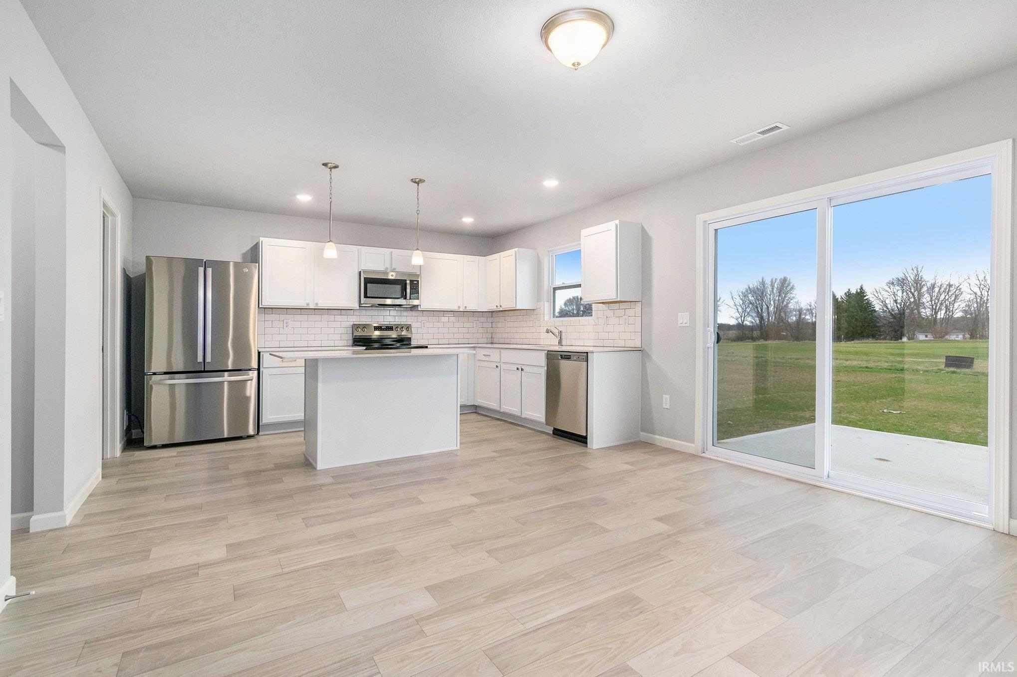 The dedicated dining room is an ideal gathering space since it can accommodate a large table and offers open sight lines into the kitchen and access to the rear yard.