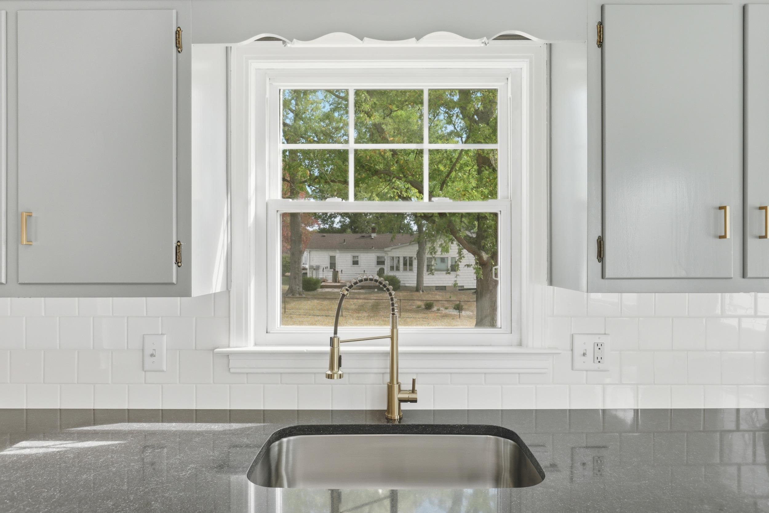 Undermount Sink, Tile Backsplash, New Fixtures & Solid Surface Countertops.