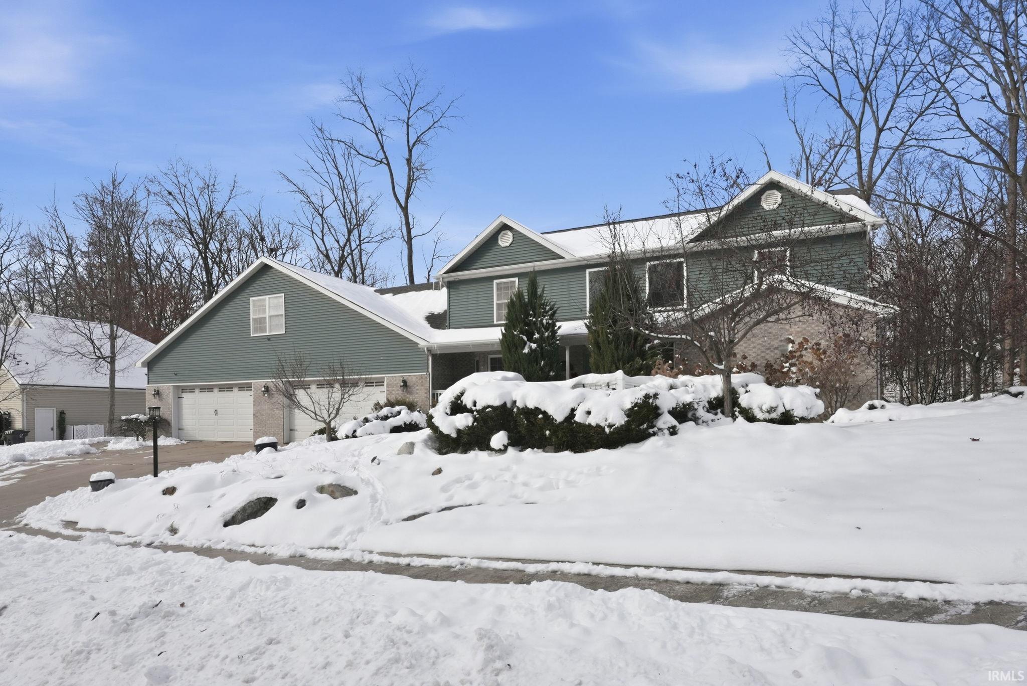 Traditional-style house with brick siding and an attached garage