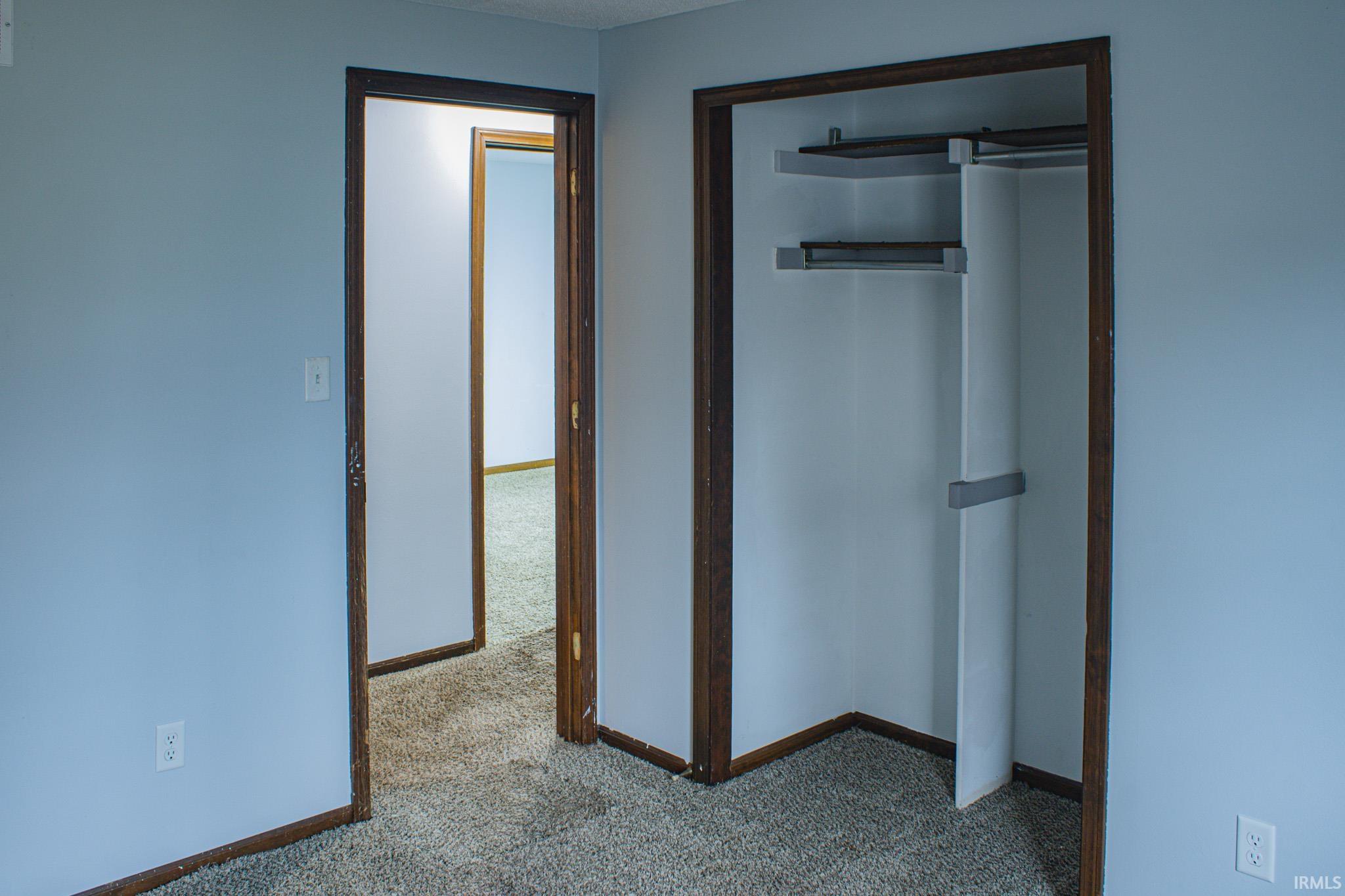 Unfurnished bedroom featuring carpet flooring and a closet
