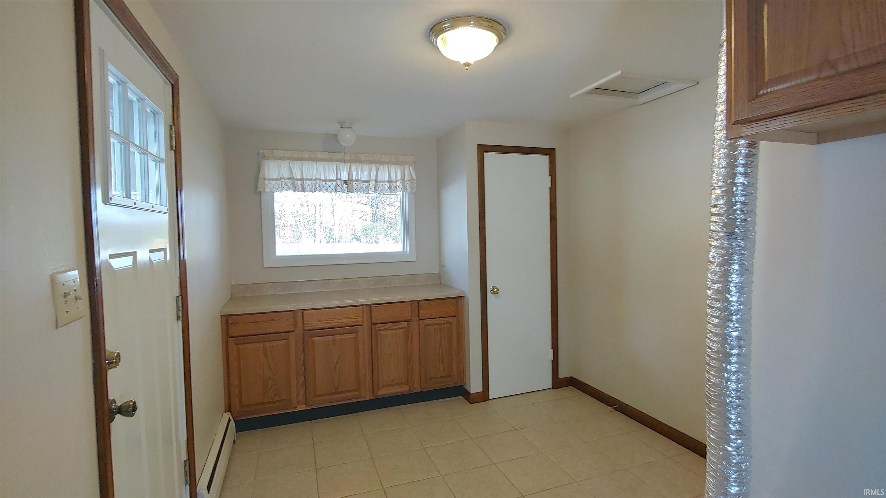 laundry with counter and cabinets