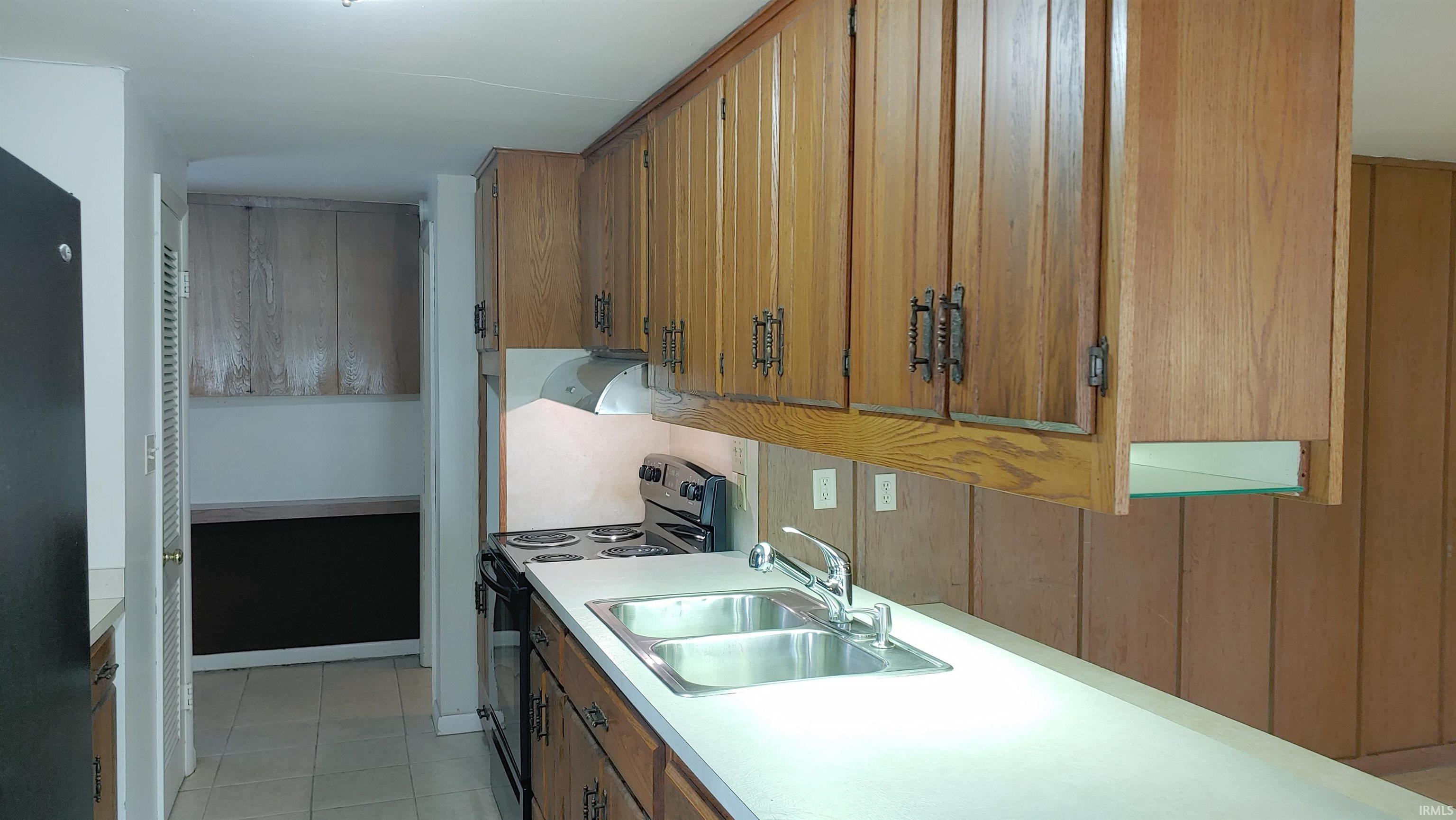 Kitchen featuring stainless sink and under cabinet lighting