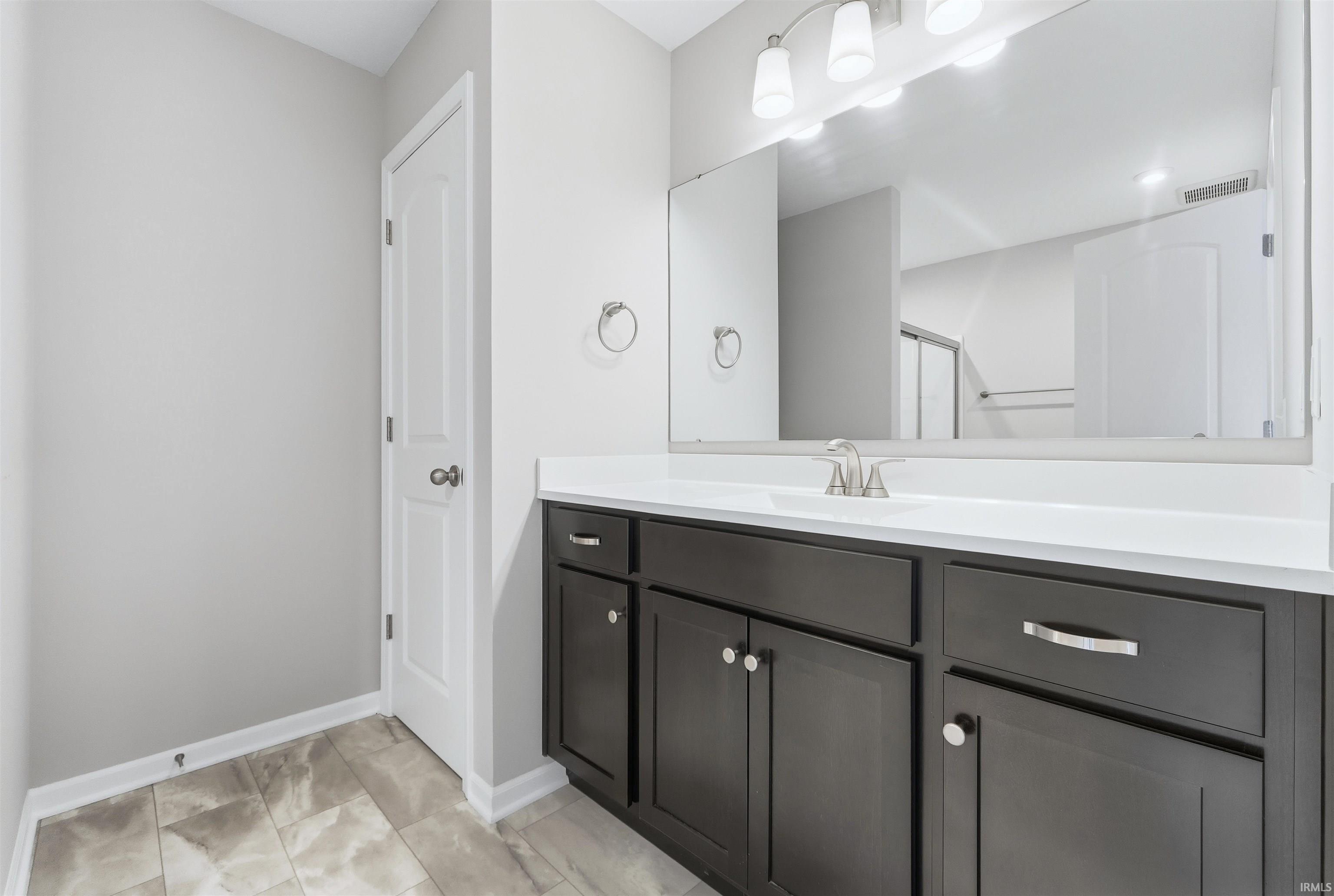 Owner Suite Bathroom with vanity and fiberglass shower