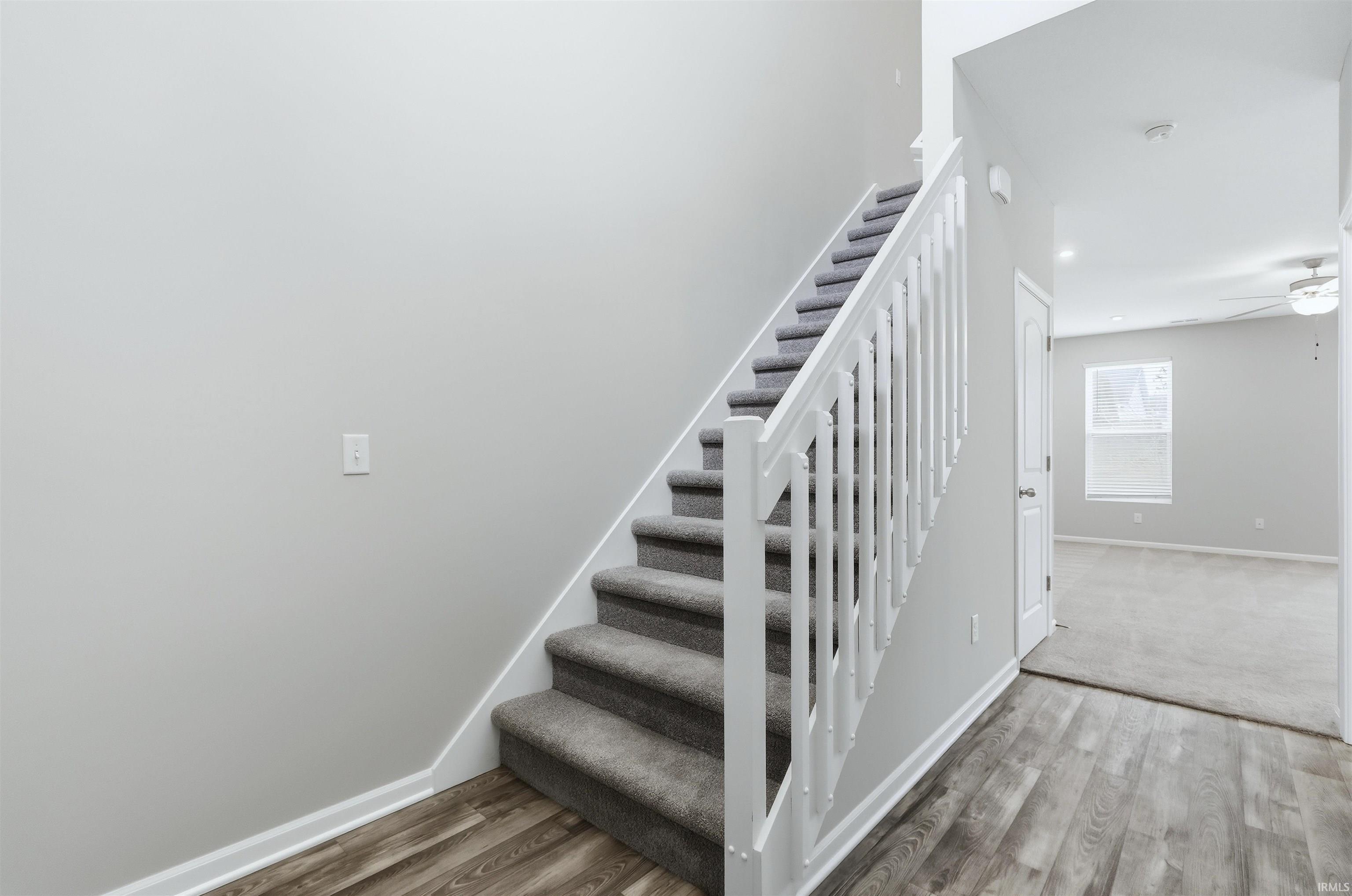 Foyer Stairs featuring vinyl plank flooring