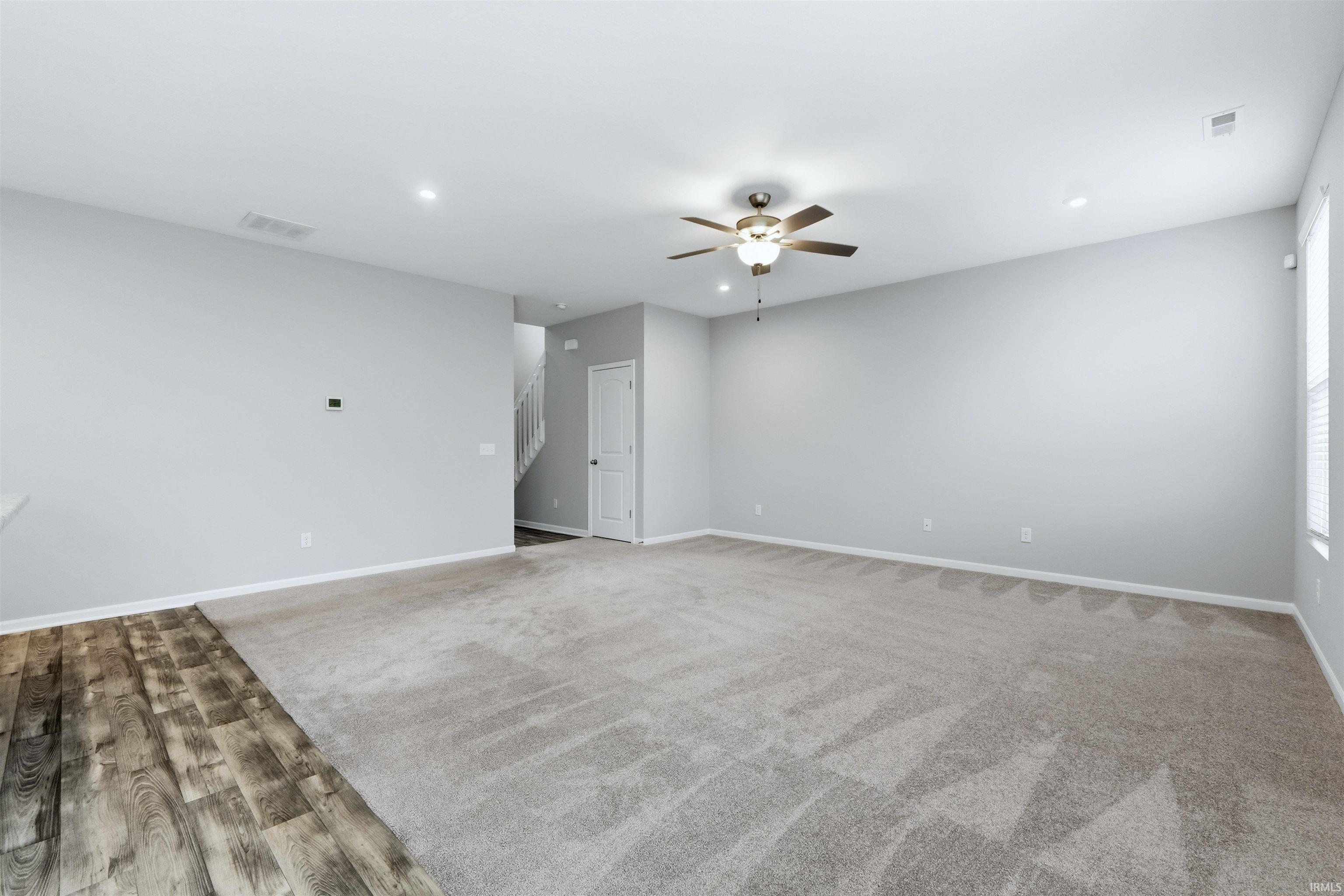 Great Room featuring ceiling fan, recessed lighting, and light carpet