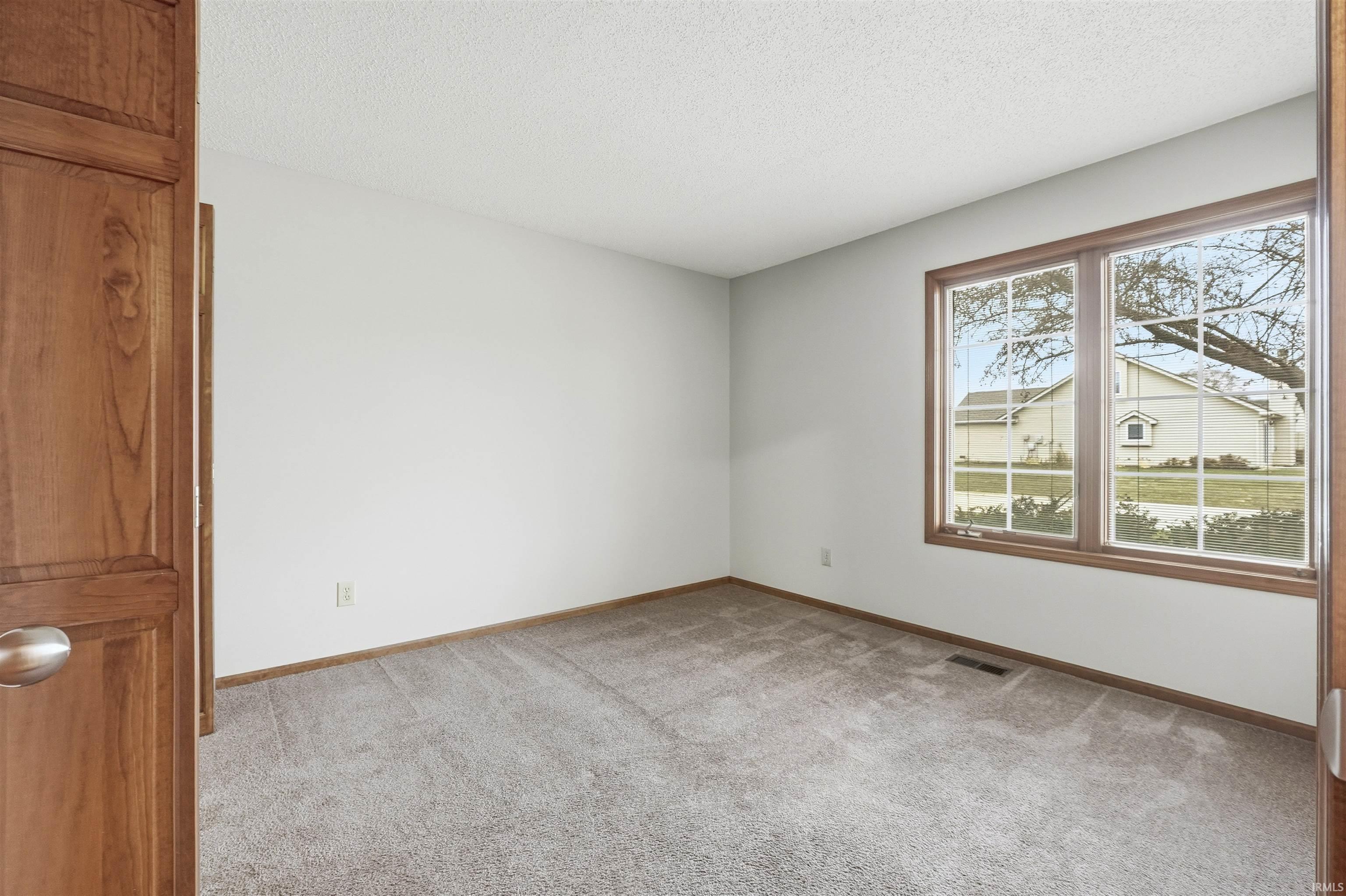 Bedroom or Office with light walls and carpet