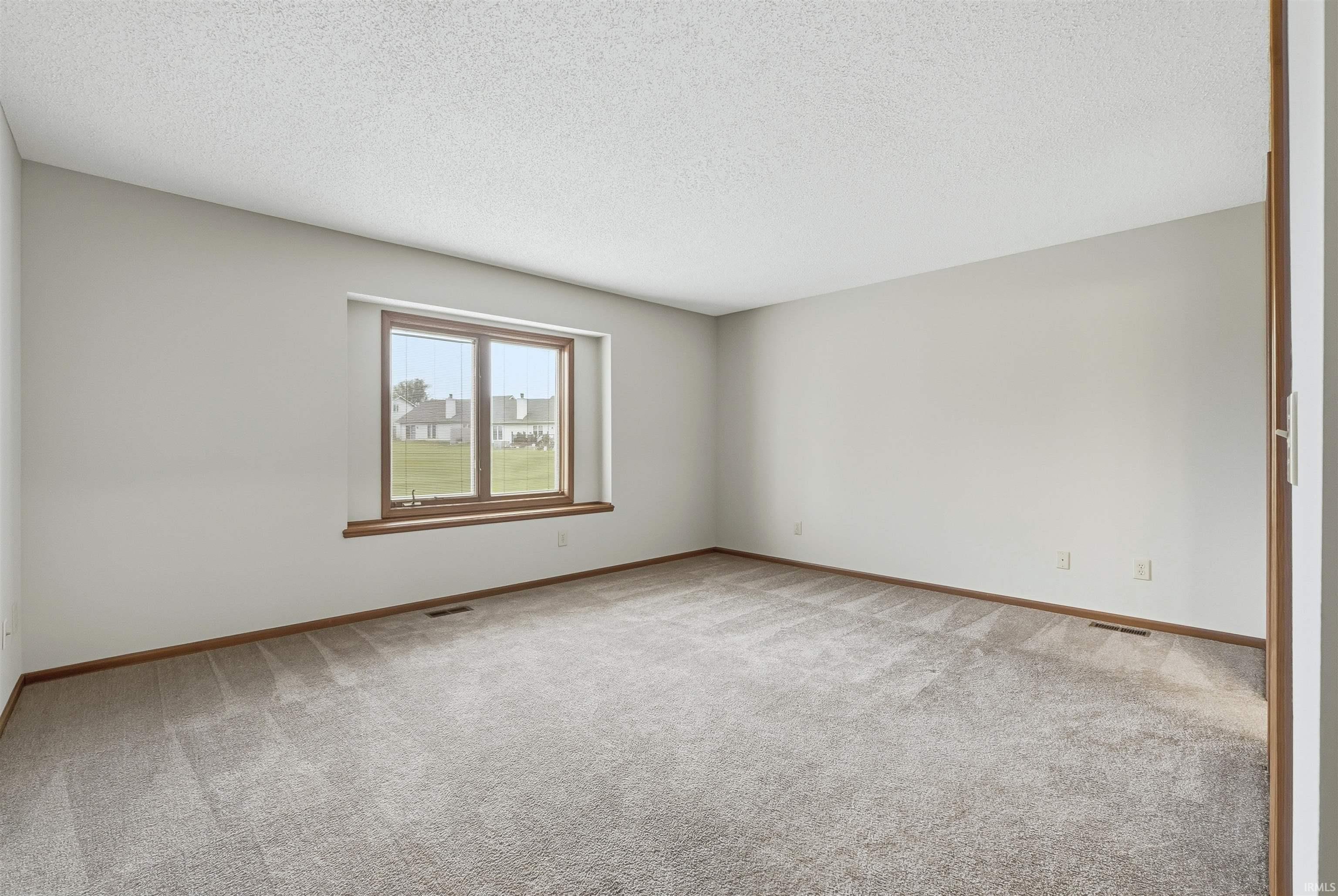 Bedroom featuring light colored carpet and a light walls