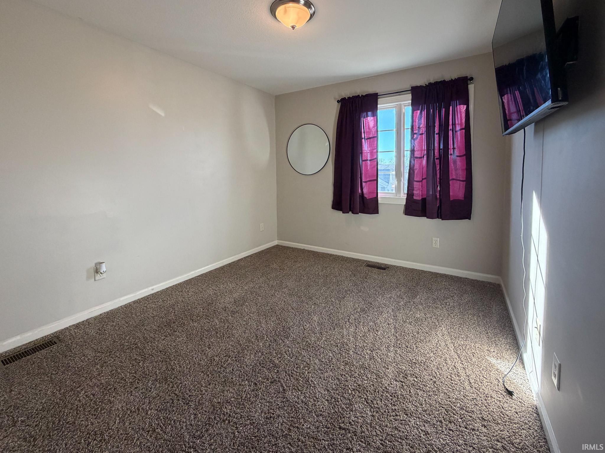 Unfurnished room with carpet flooring