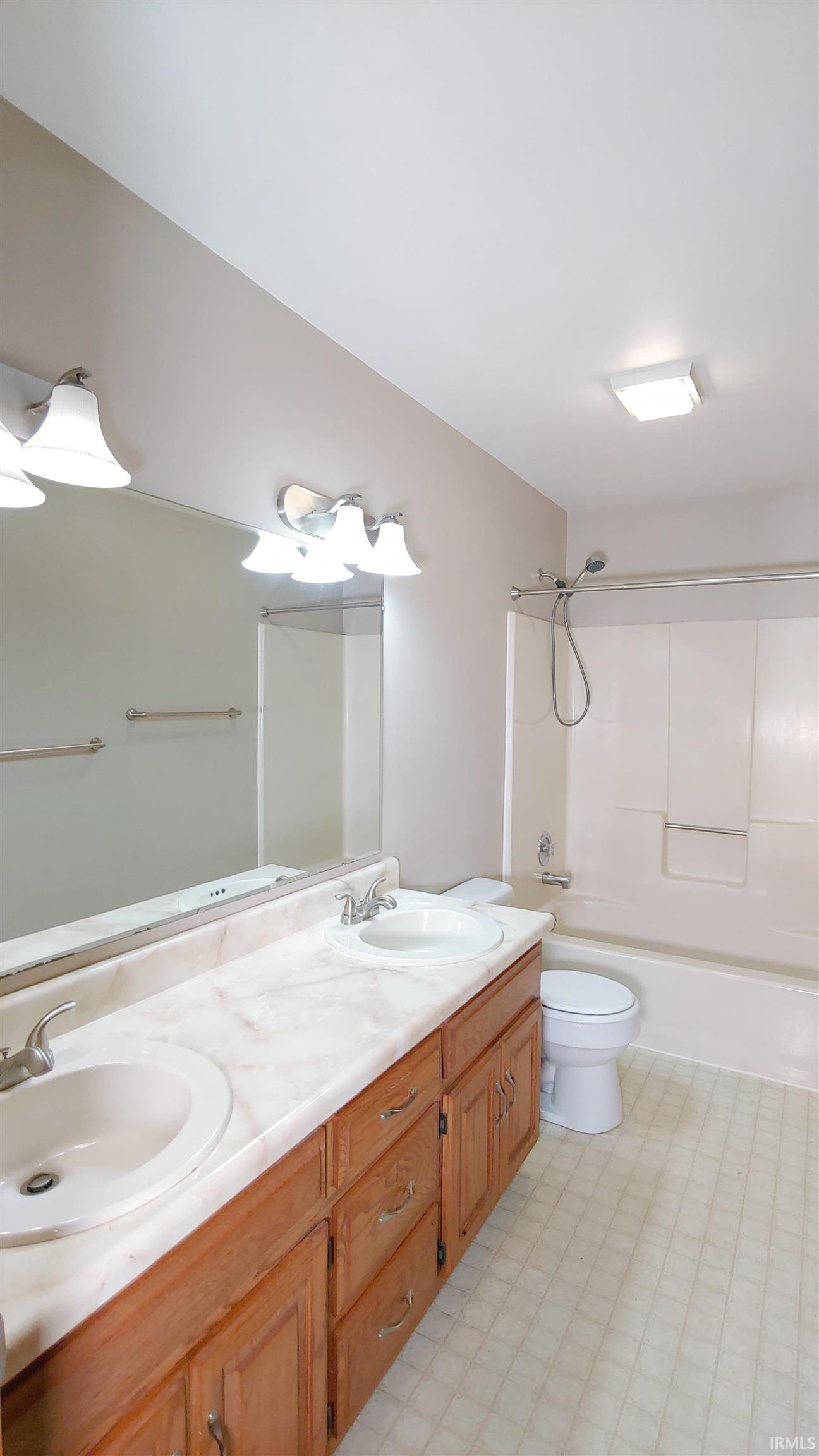 Full bath with double vanity and tub/shower combination