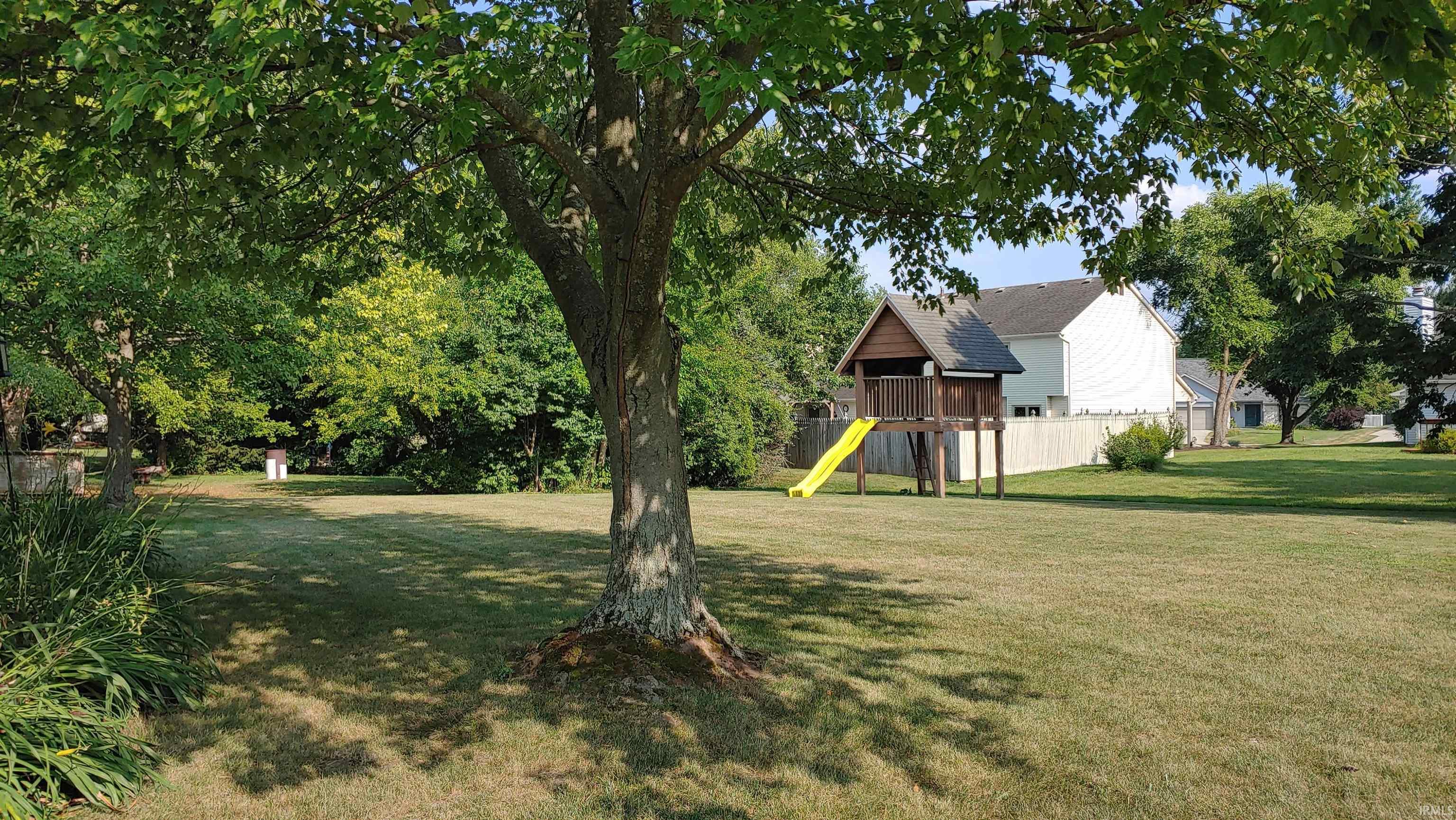 View of backyard with a playset