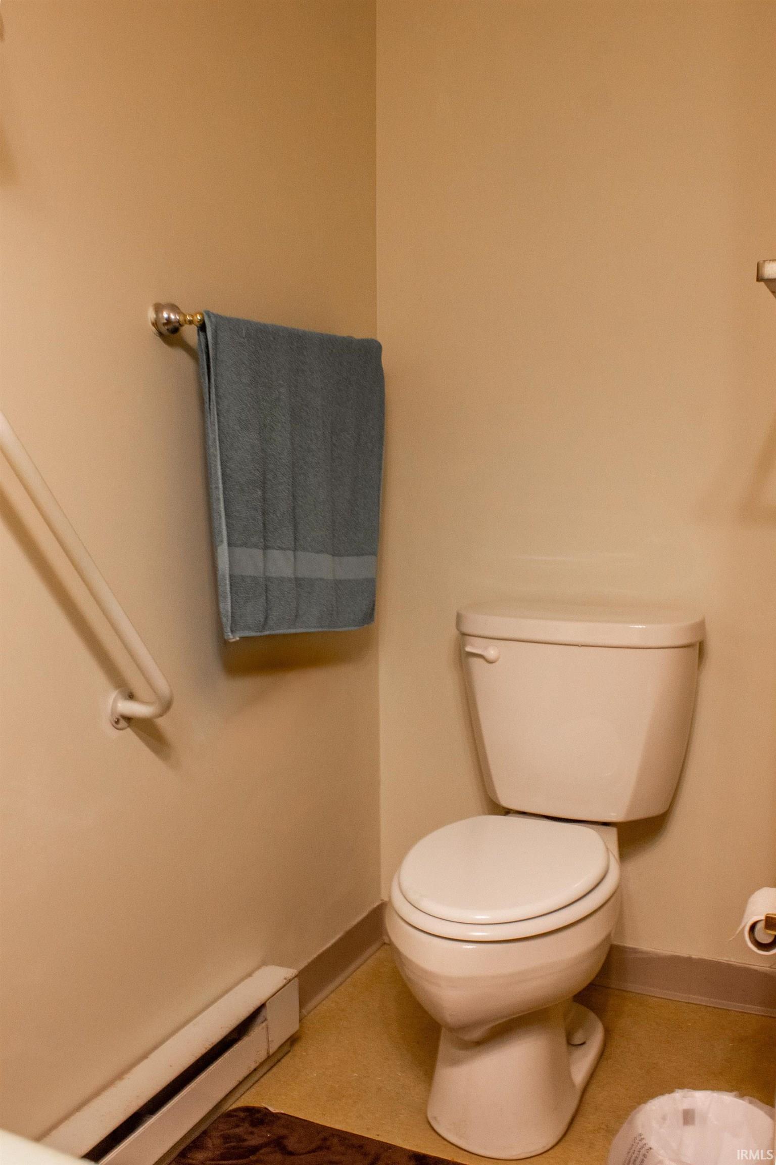 Half bathroom featuring a baseboard radiator and baseboards