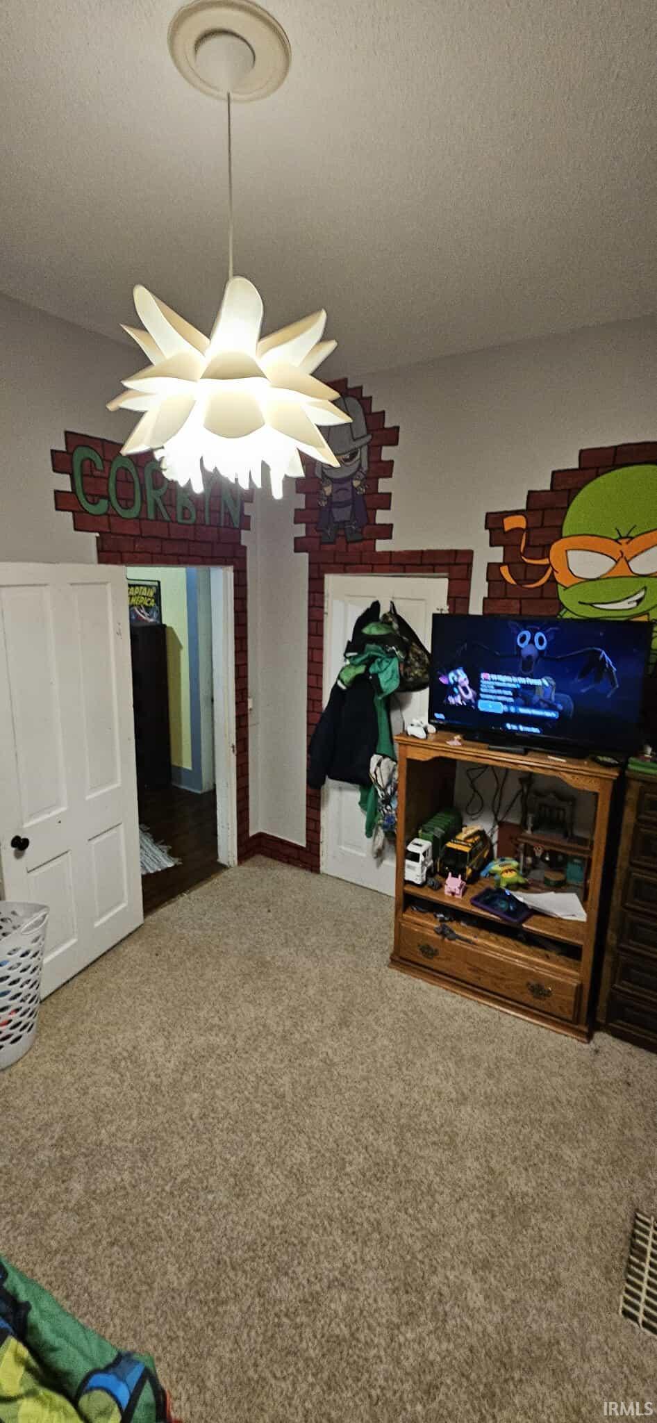 Carpeted bedroom featuring a textured ceiling