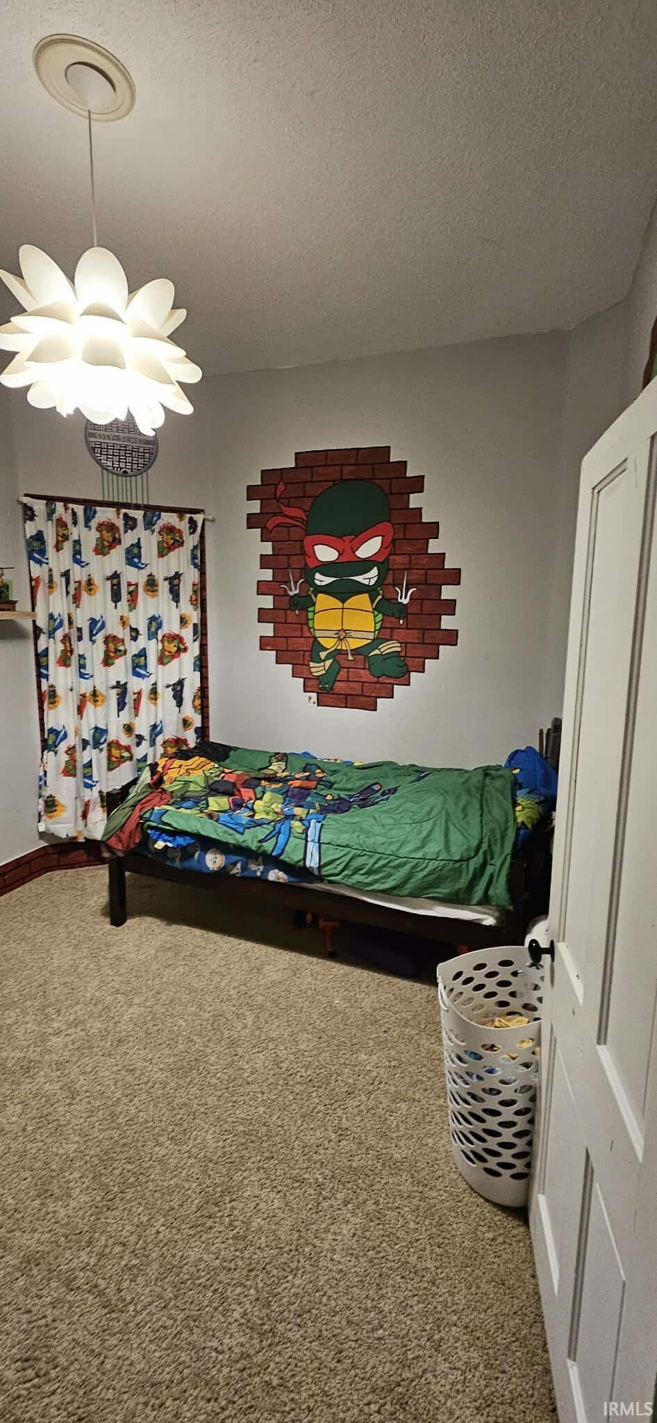 Carpeted bedroom with a textured ceiling