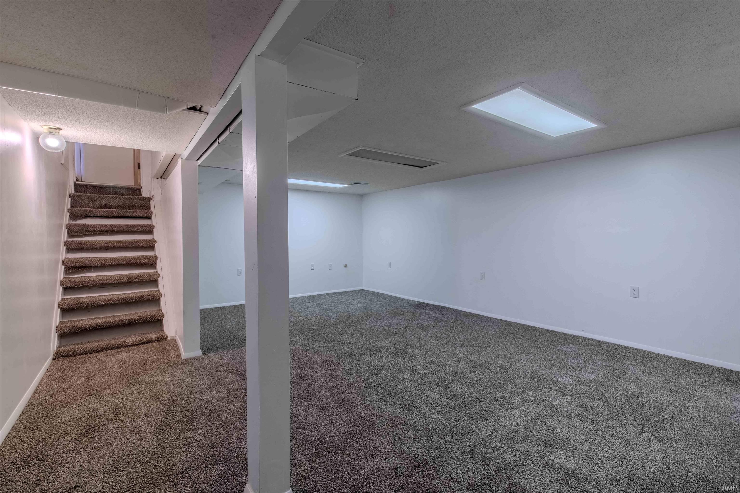 In basement W/newer flooring / Pad, finished area of basement.