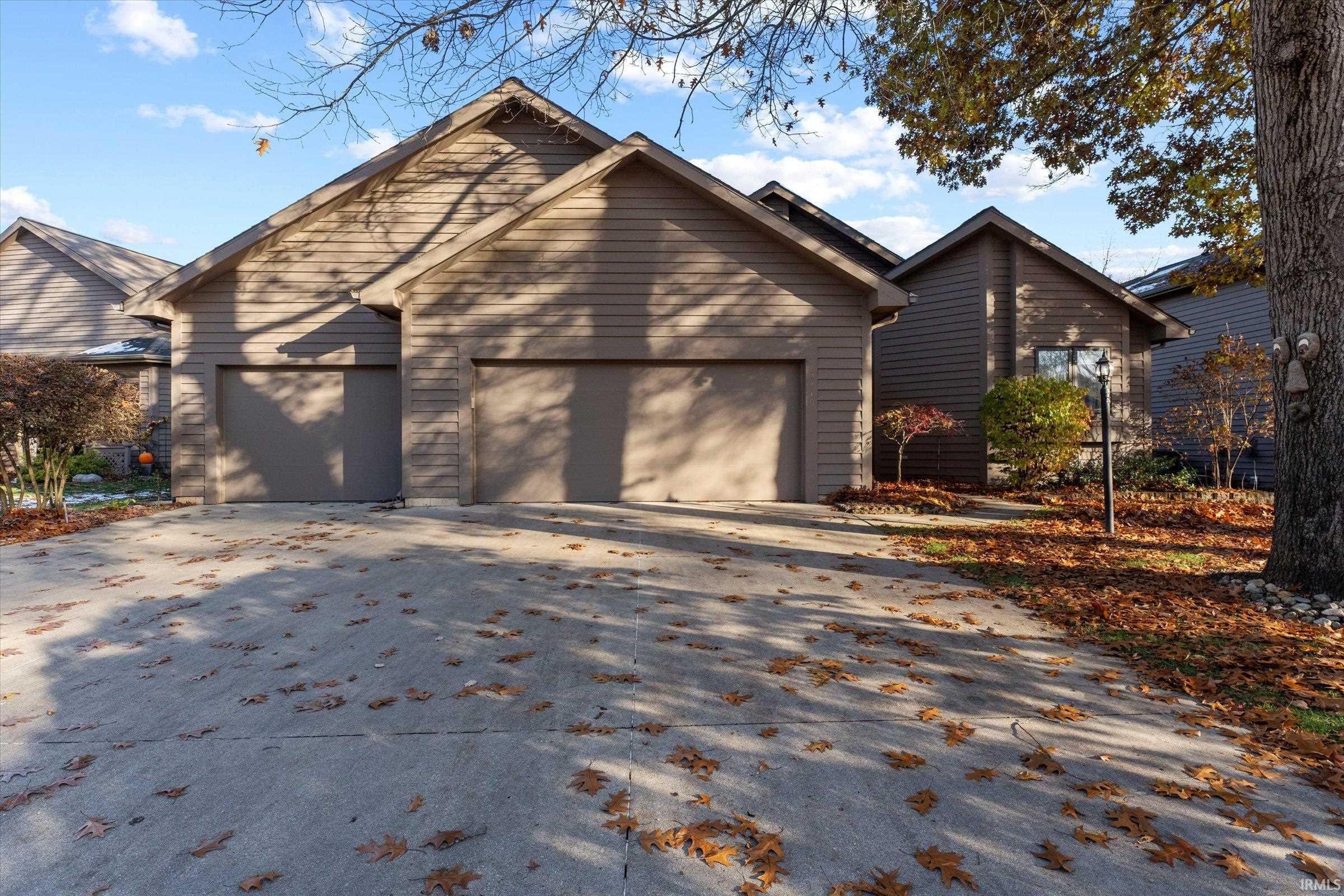View of front facade featuring concrete driveway and a garage