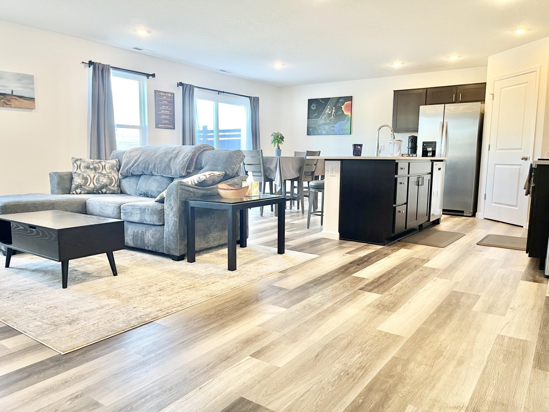 Living room with light wood-style flooring and recessed lighting