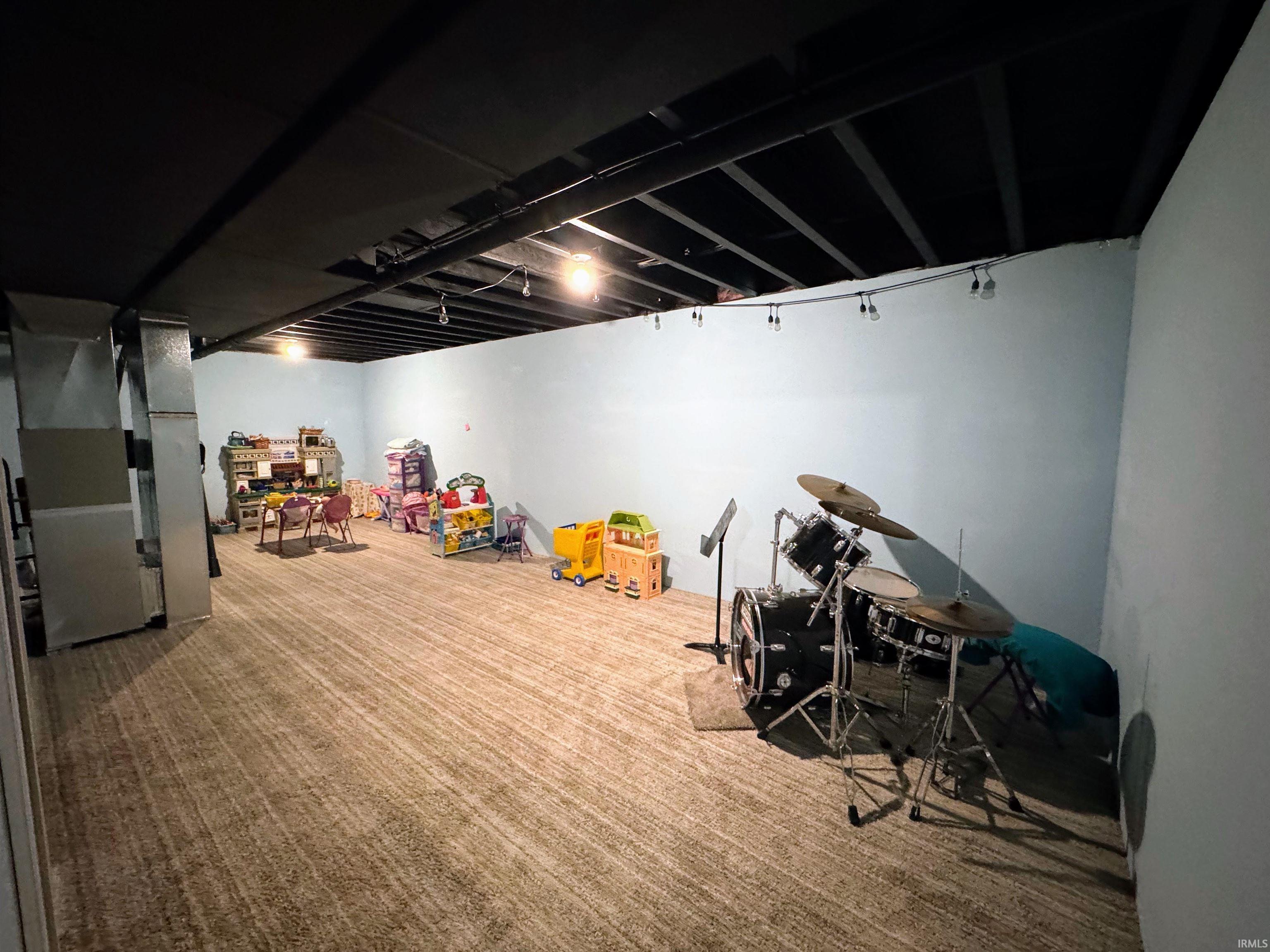 Game room with carpet floors and heating unit