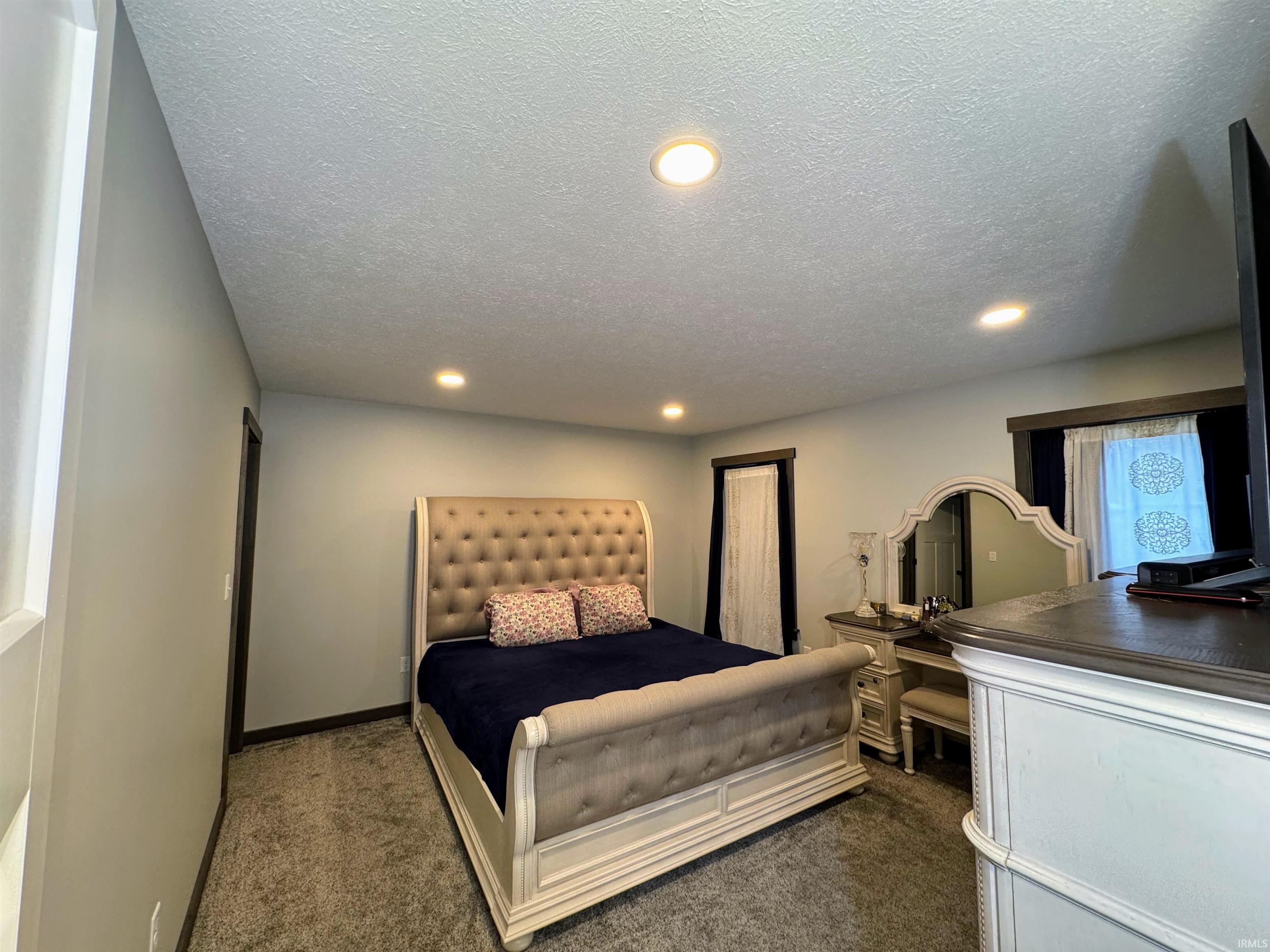 Bedroom featuring carpet, recessed lighting, and a textured ceiling