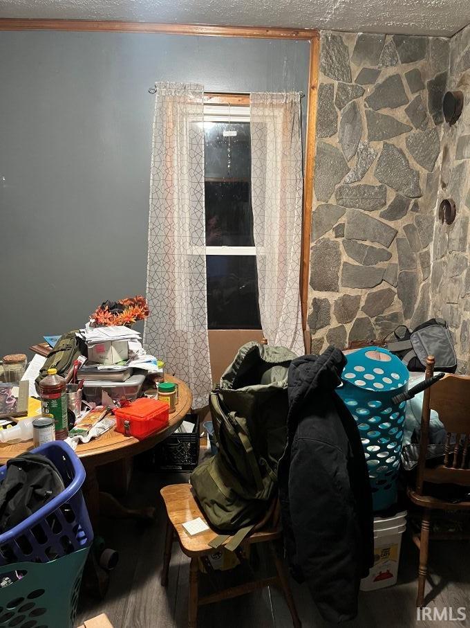 Misc room with a textured ceiling and ornamental molding