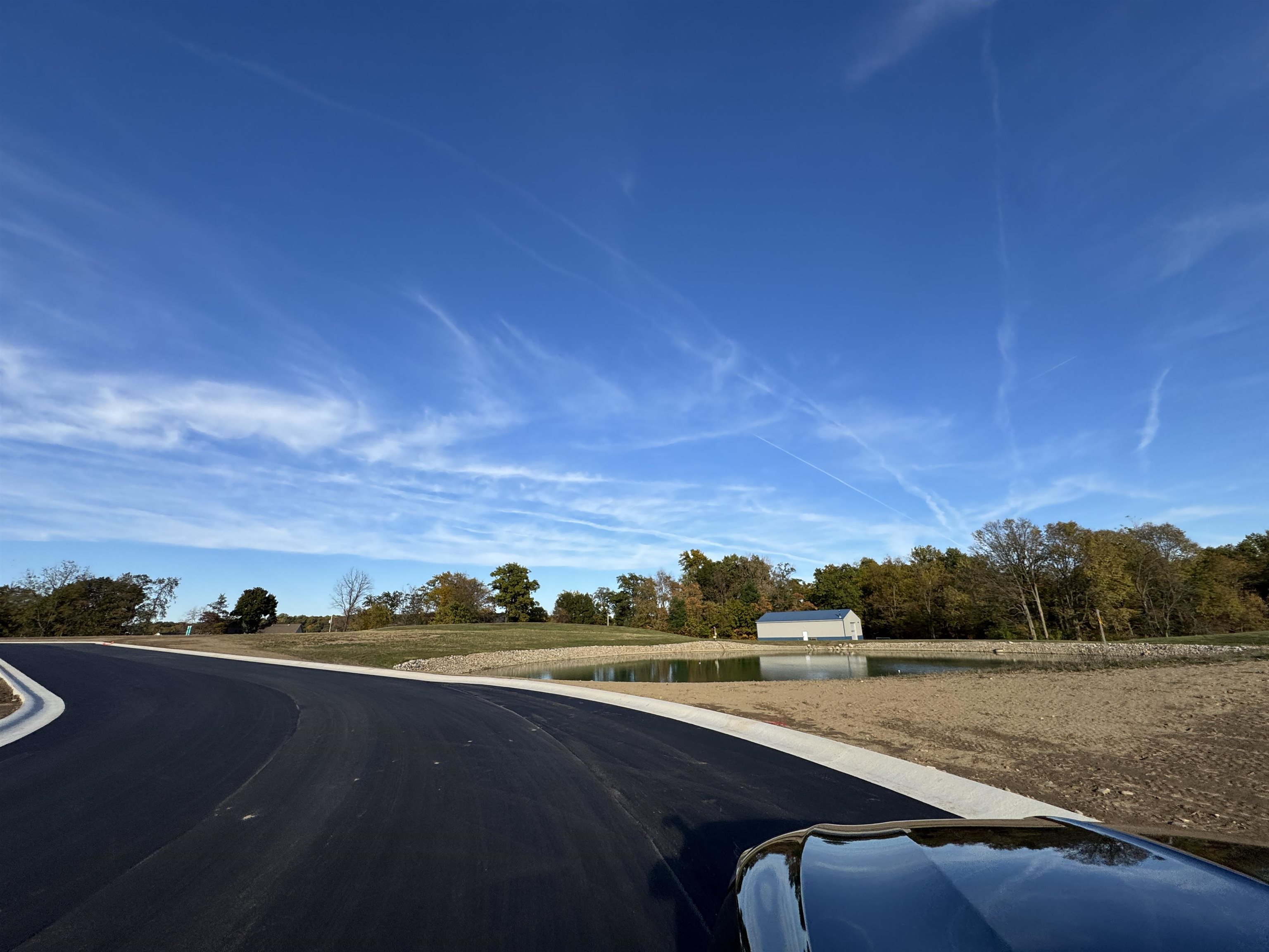 View of asphalt road featuring a water view
