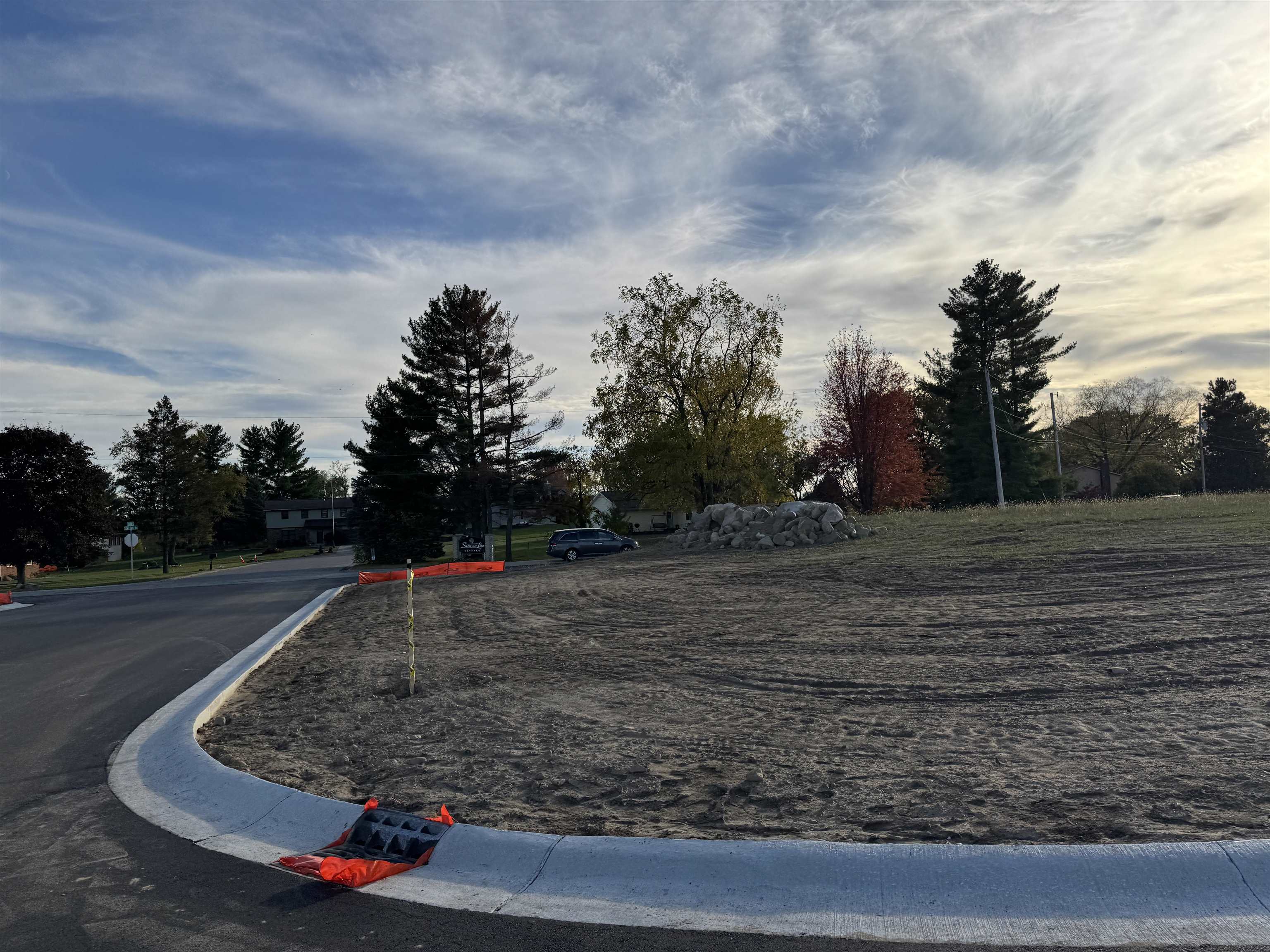 View of asphalt street featuring curbs