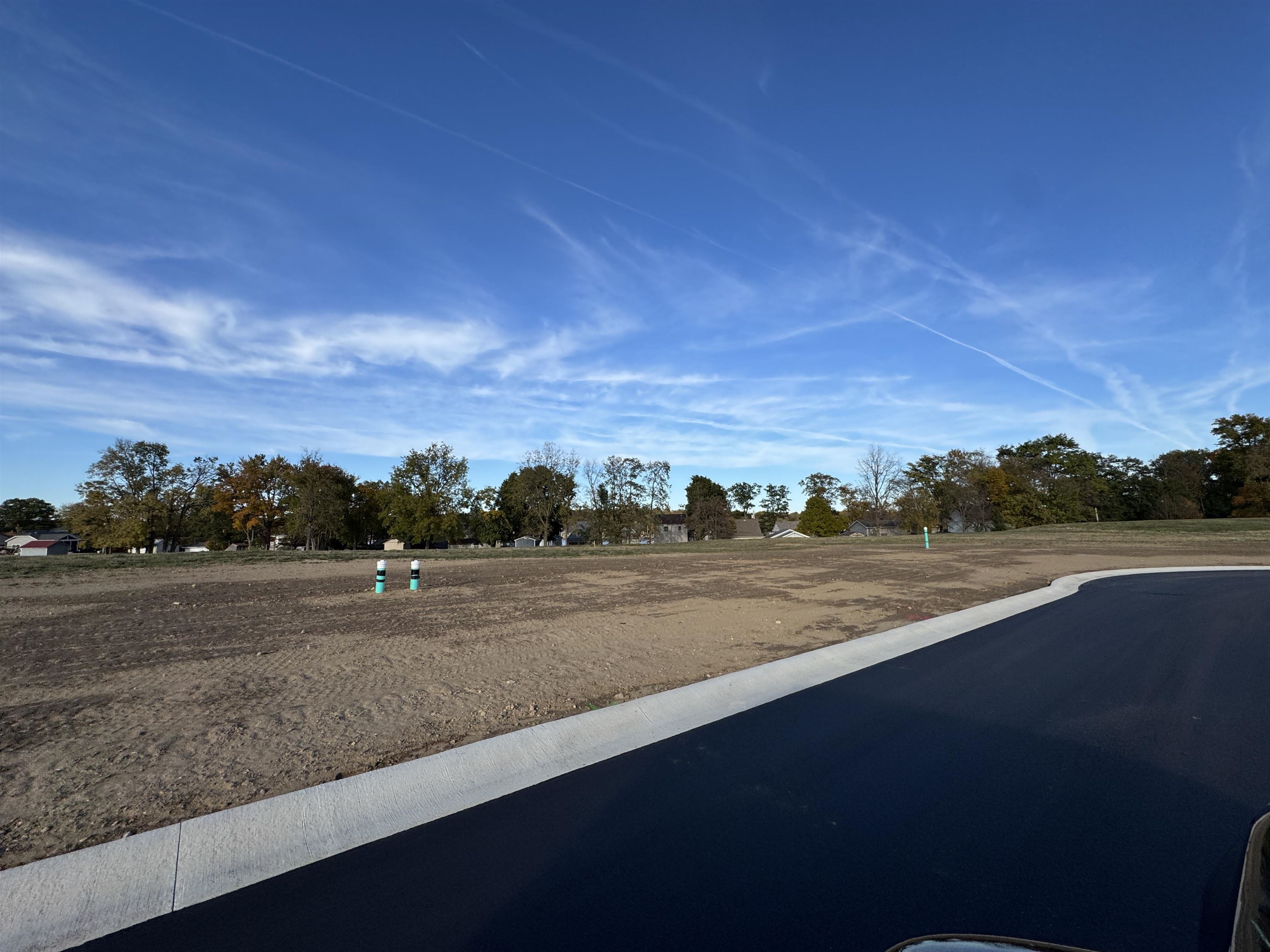 View of asphalt road featuring curbs