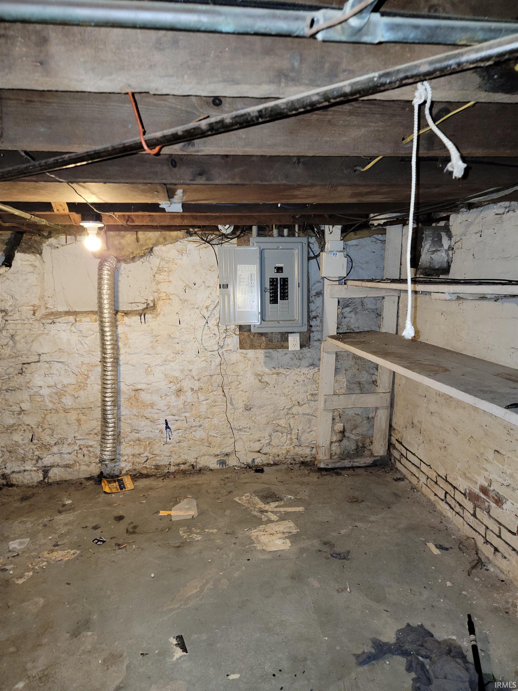 Unfinished basement with electric panel
