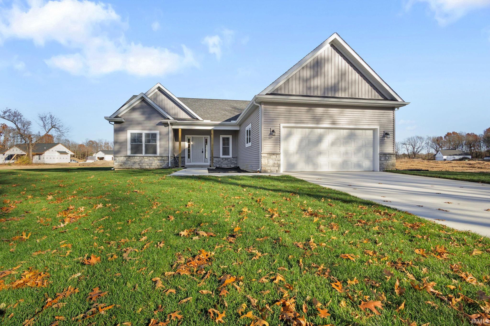 Craftsman house featuring stone siding, a porch, driveway, and board and batten siding