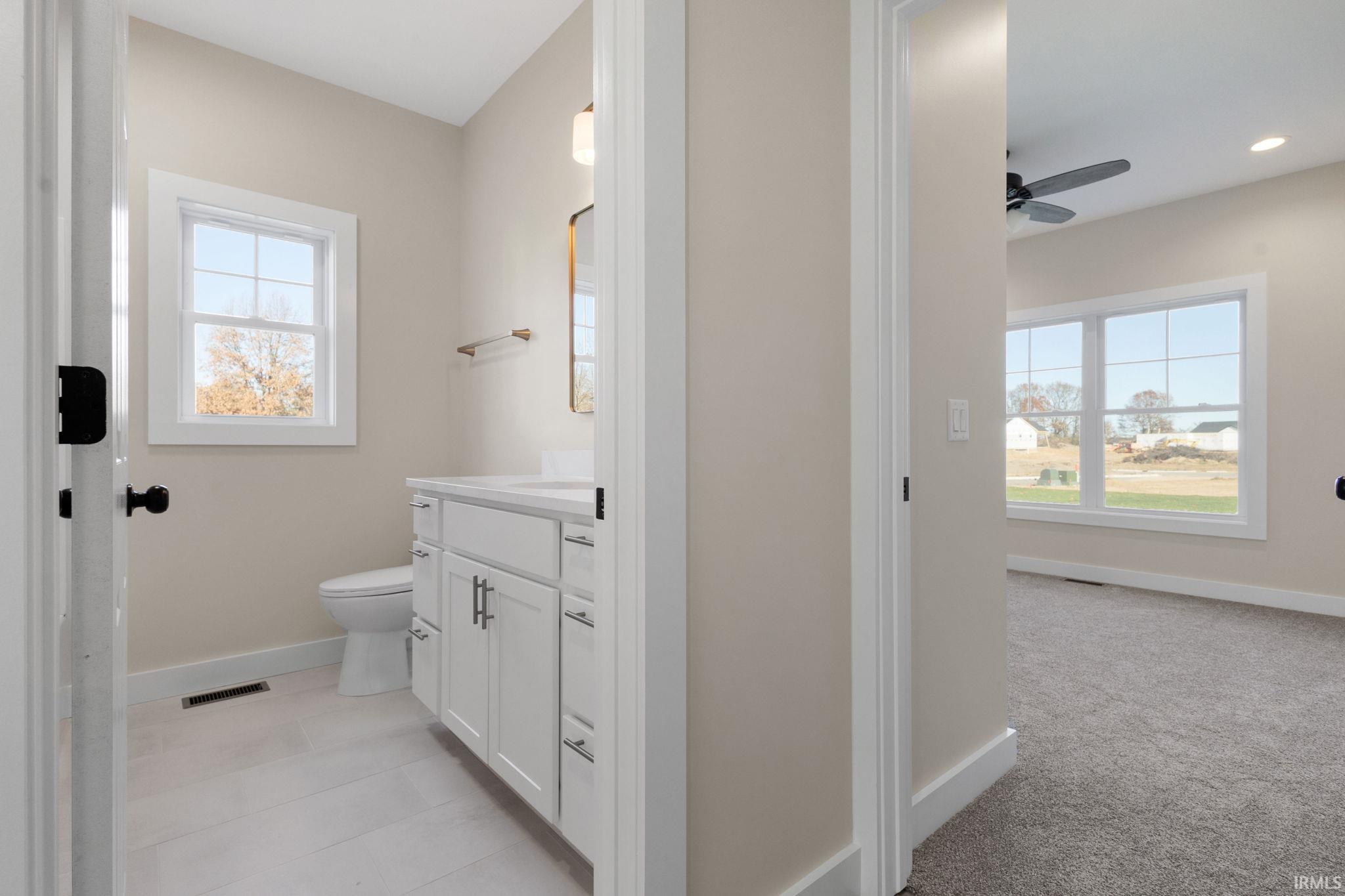 Bathroom featuring vanity and ceiling fan