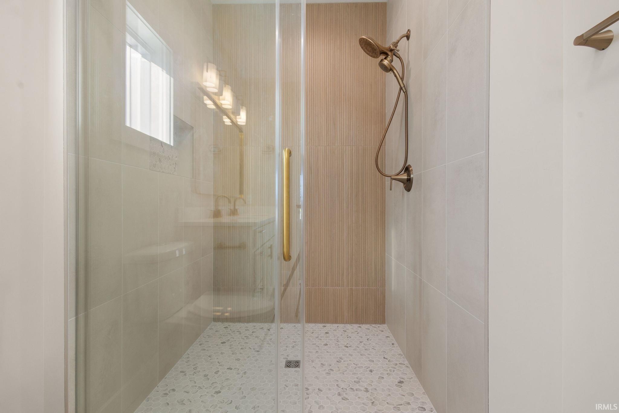 Full bathroom featuring a shower stall