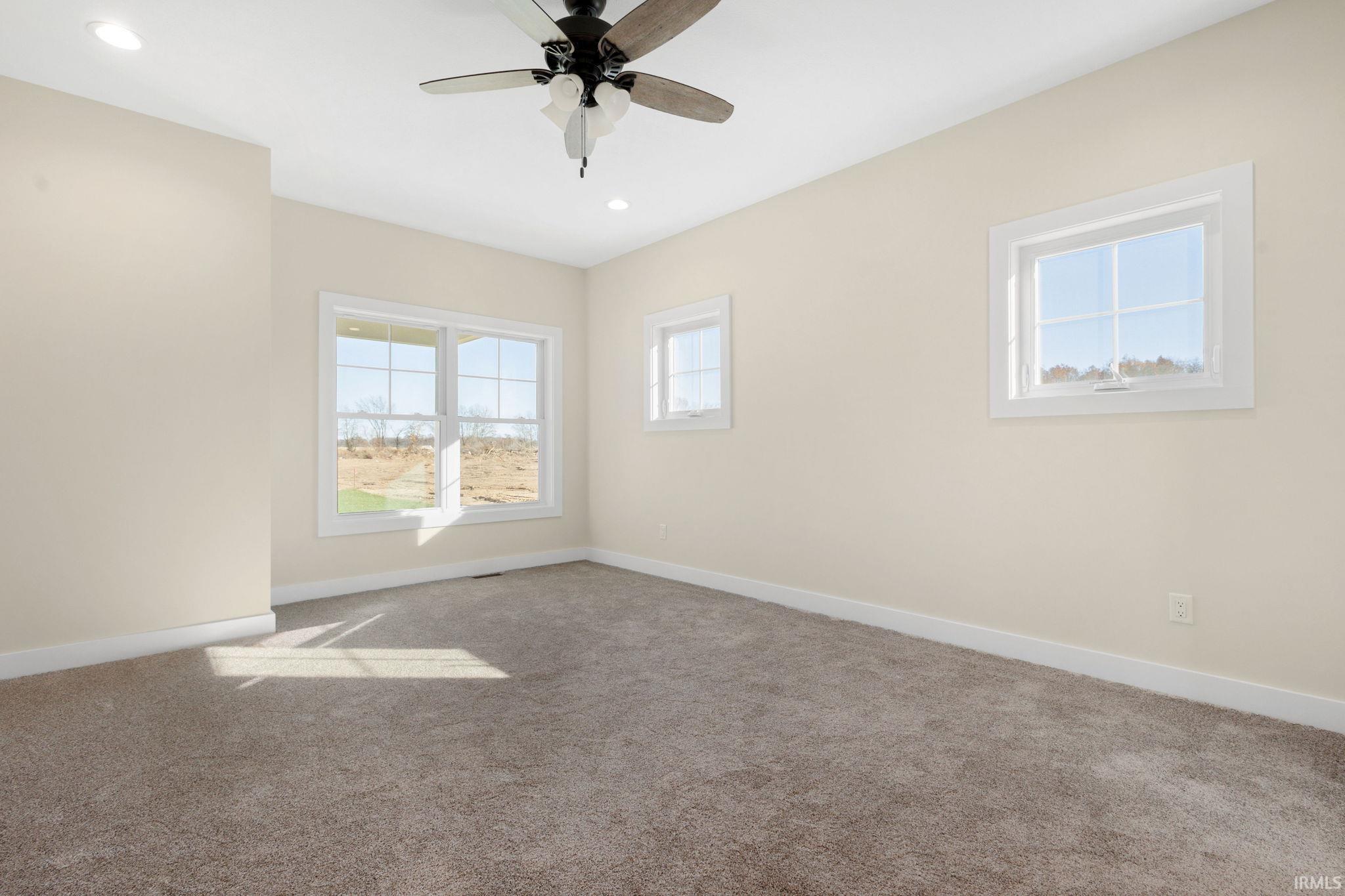 Spare room featuring carpet flooring, recessed lighting, and a ceiling fan