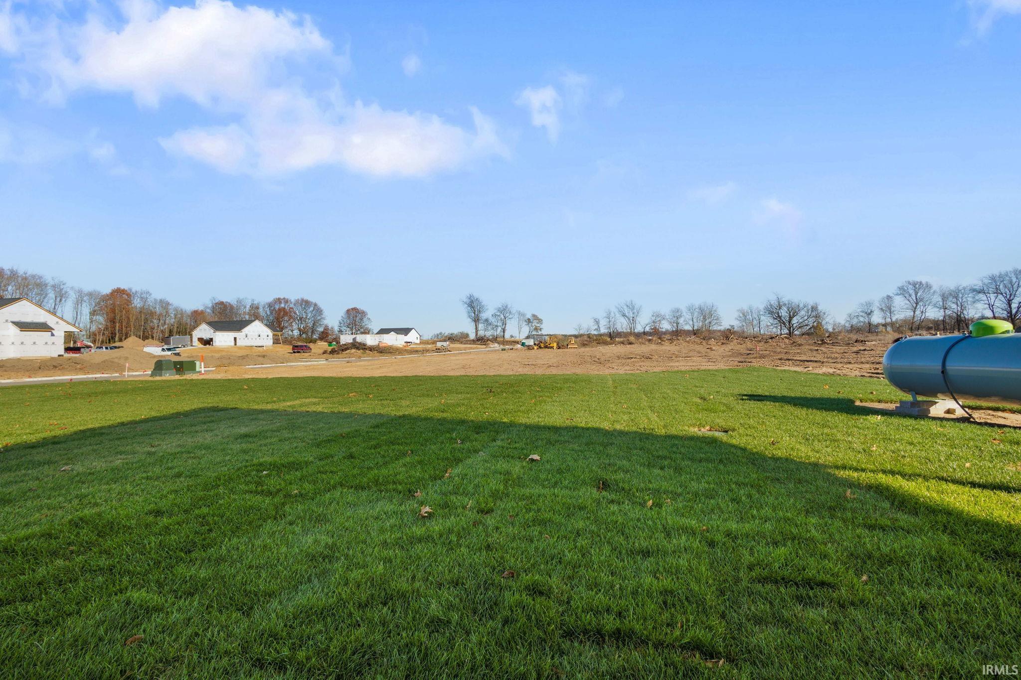View of green lawn with a rural view