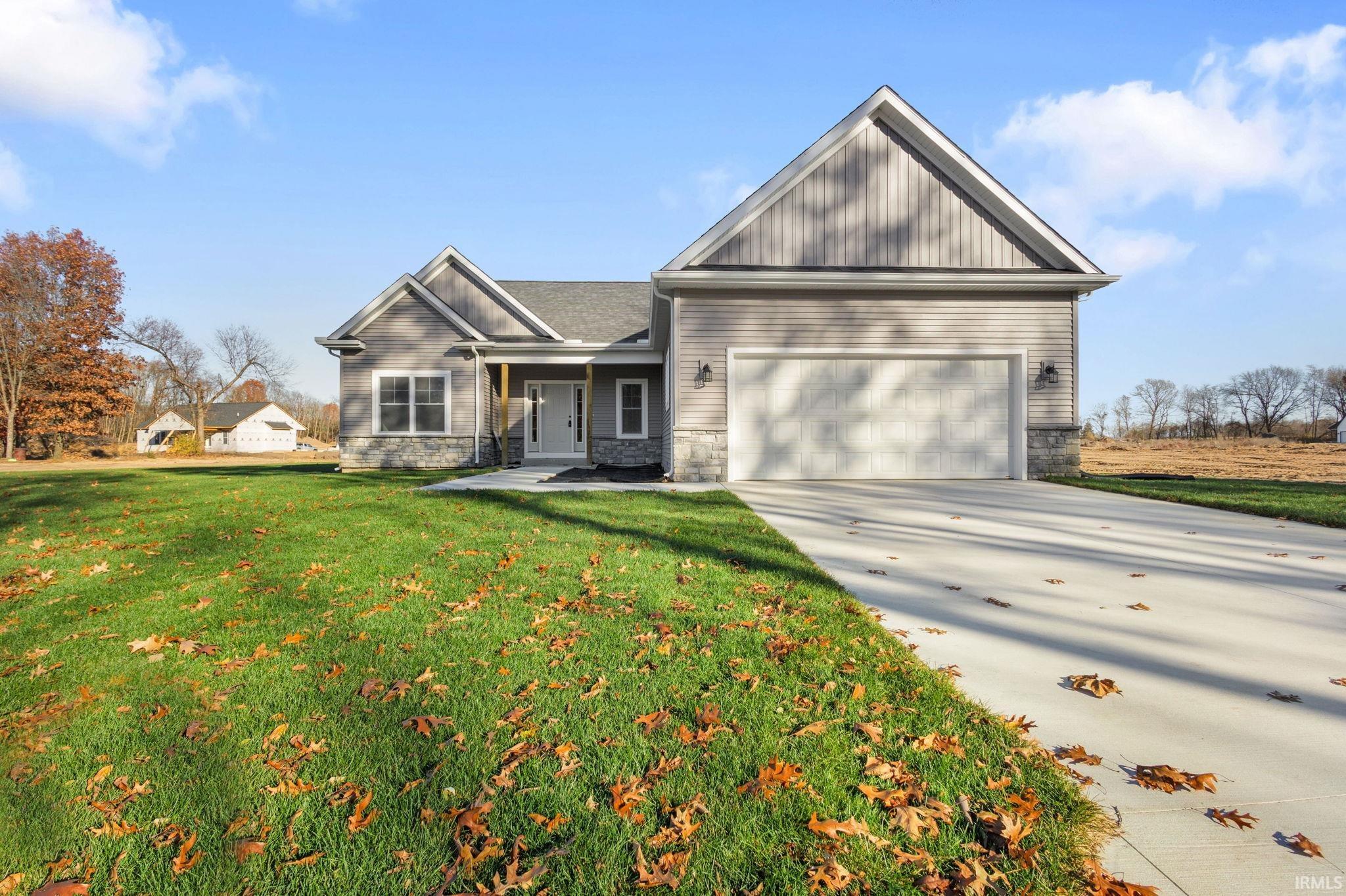 Craftsman inspired home featuring a porch, stone siding, concrete driveway, a front lawn, and an attached garage