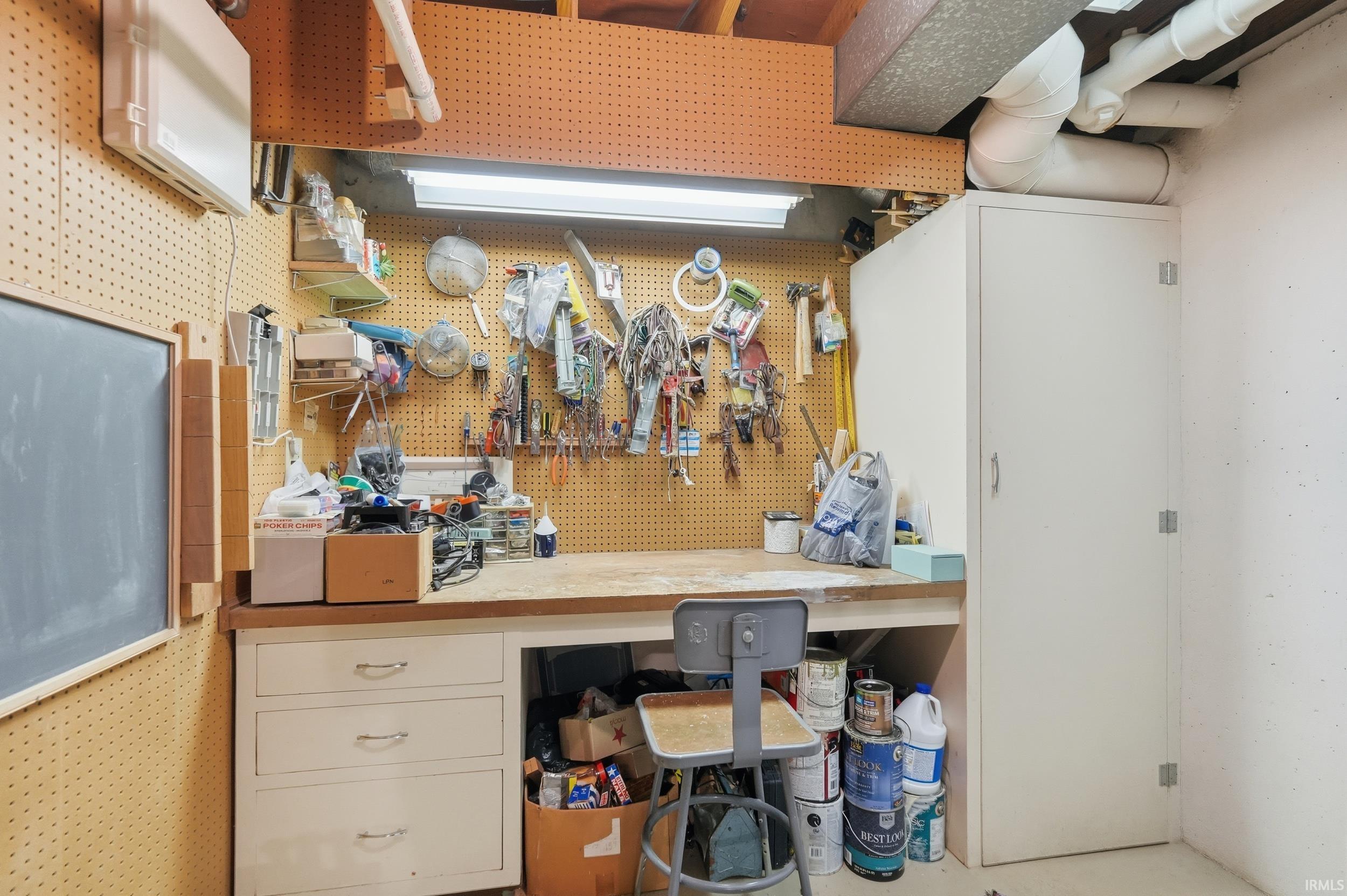 Bar with a workshop area and white cabinetry