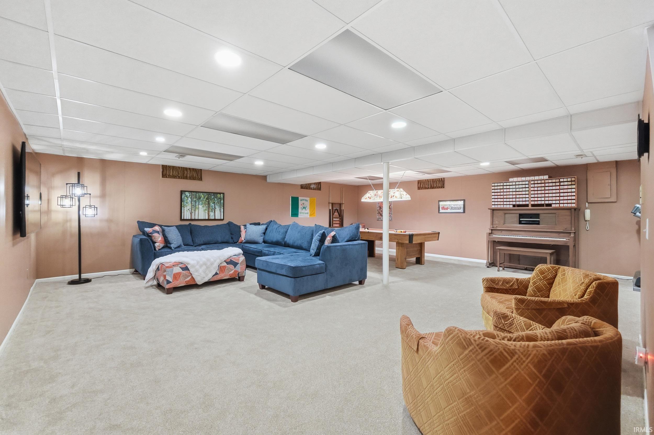 Carpeted living room featuring a paneled ceiling, recessed lighting, and pool table