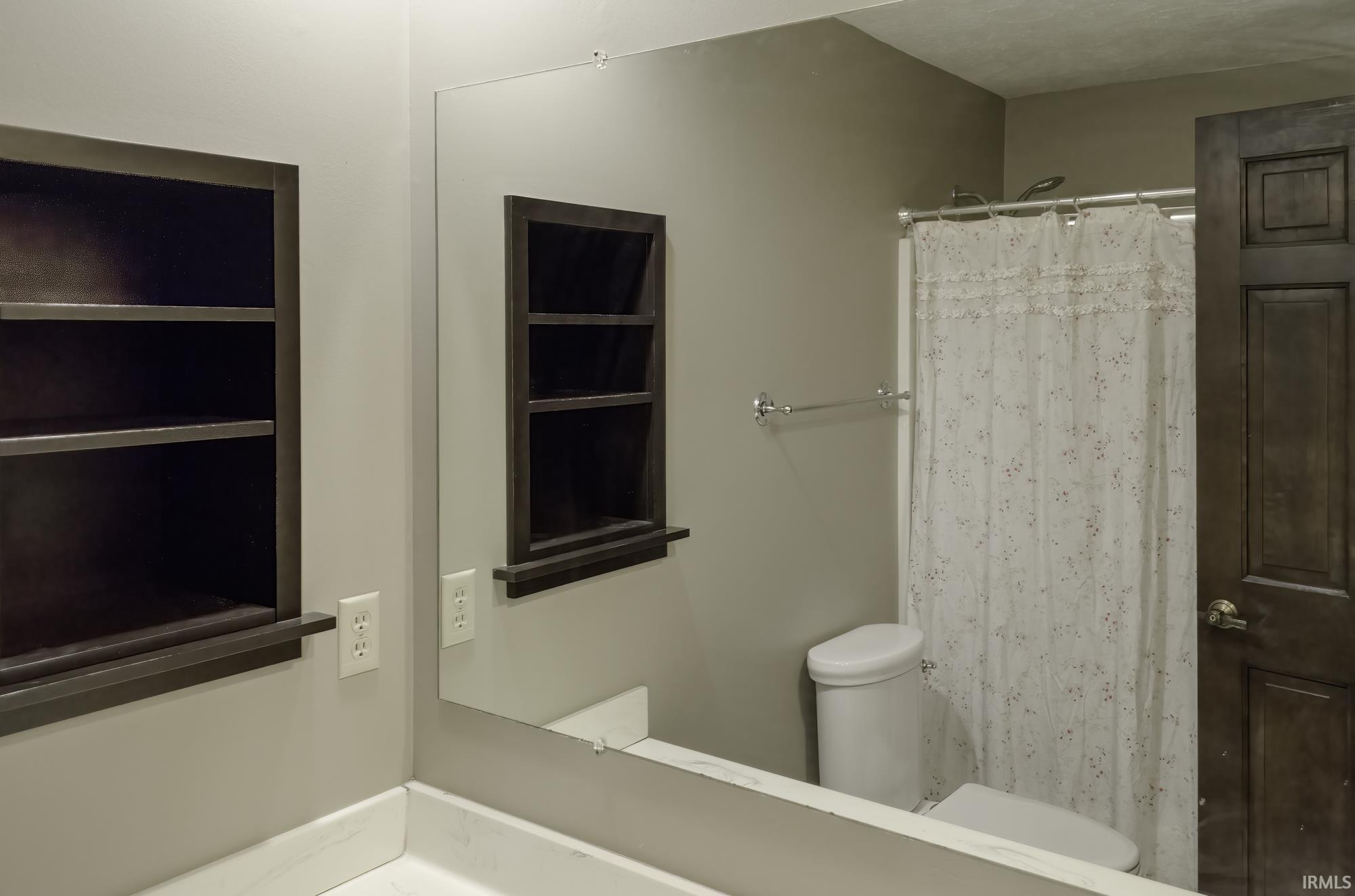 Bathroom featuring curtained shower and vanity