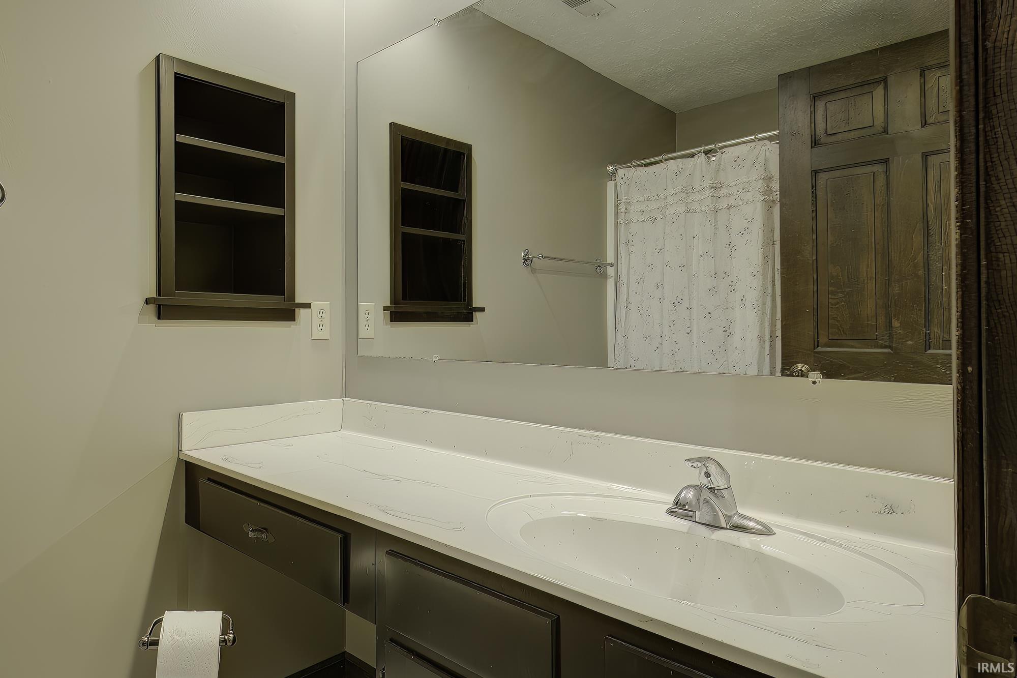 Full bath featuring vanity and a shower with shower curtain