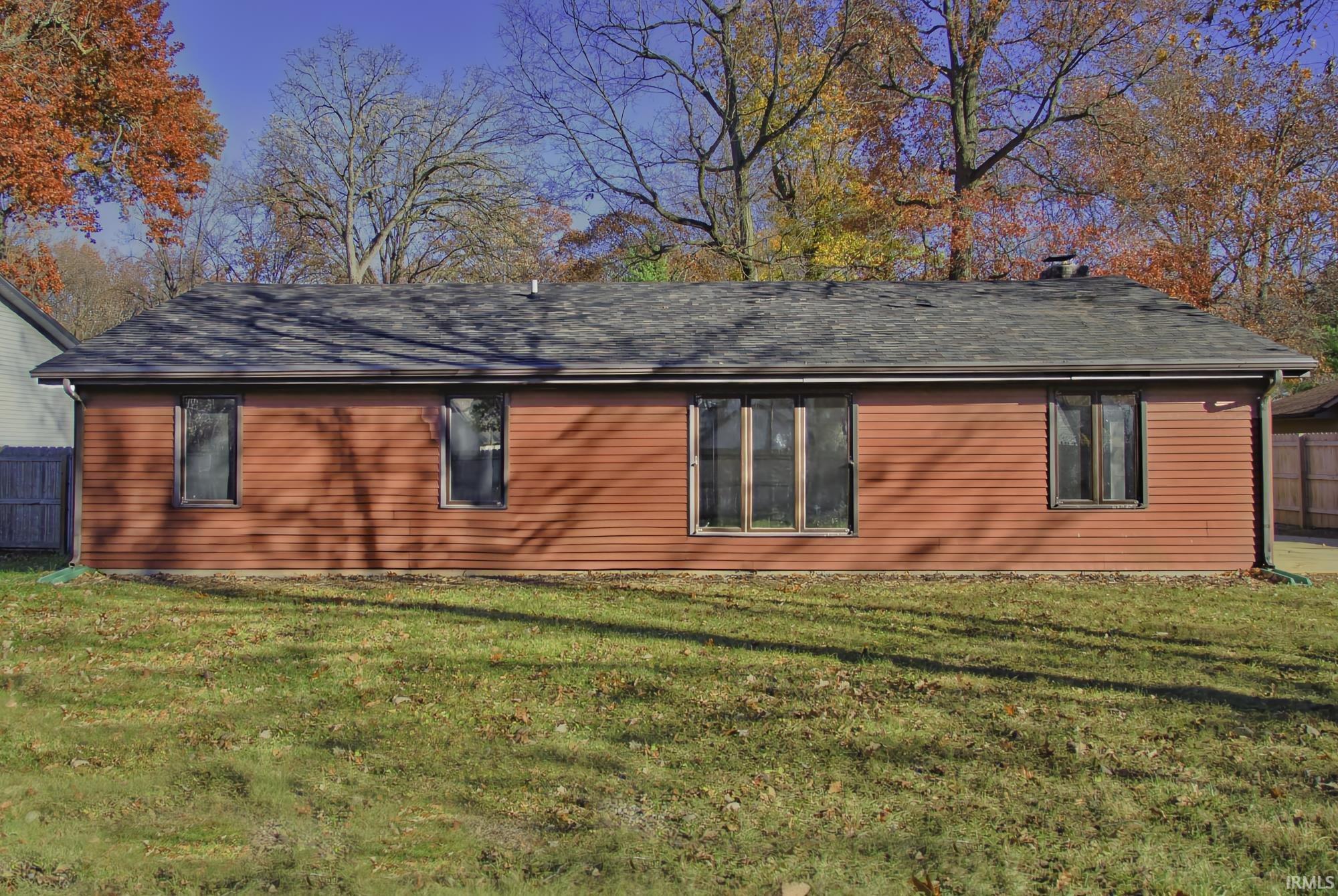 View of side of home with roof with shingles