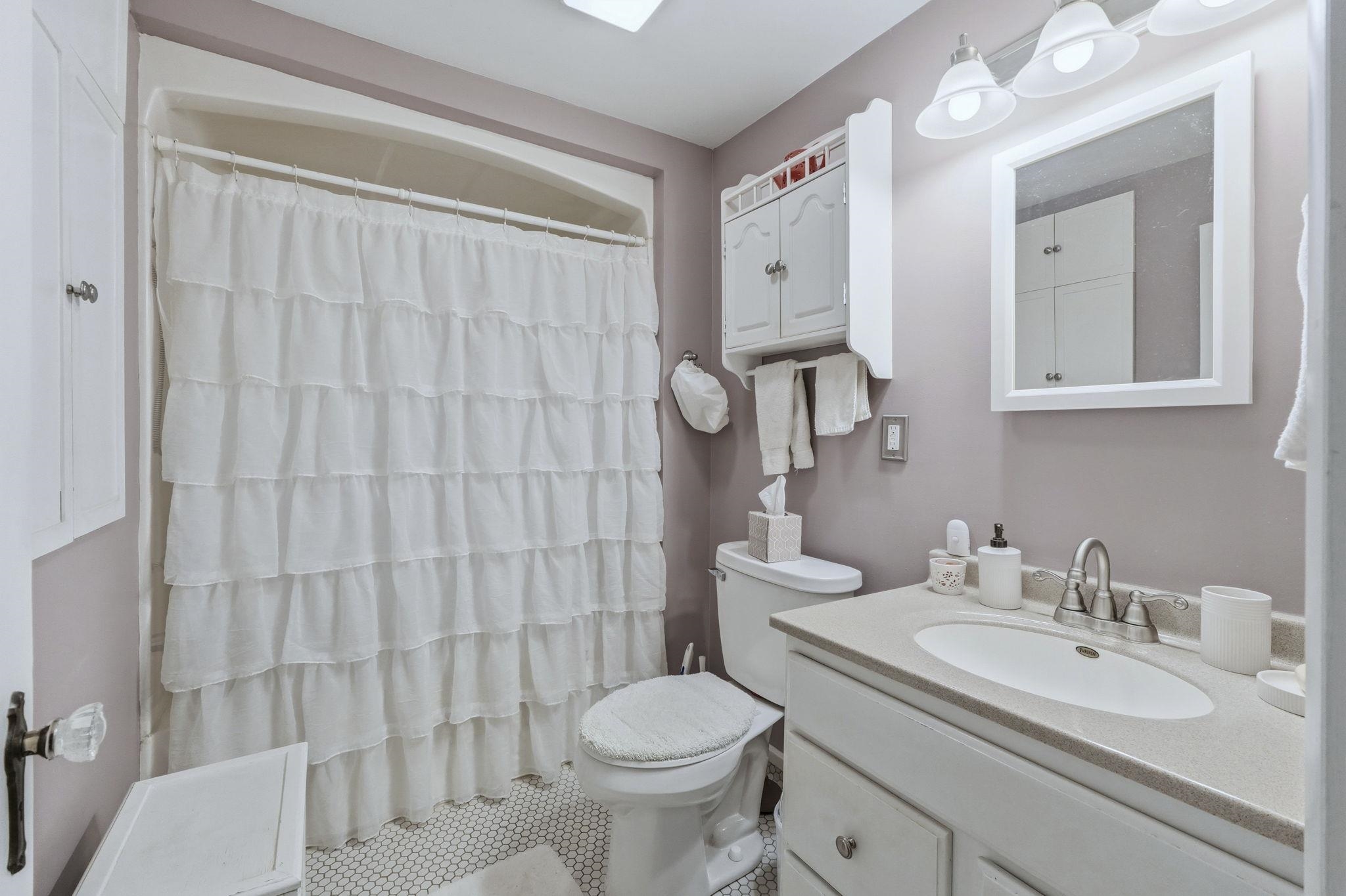 Full bath featuring vanity and a shower with curtain
