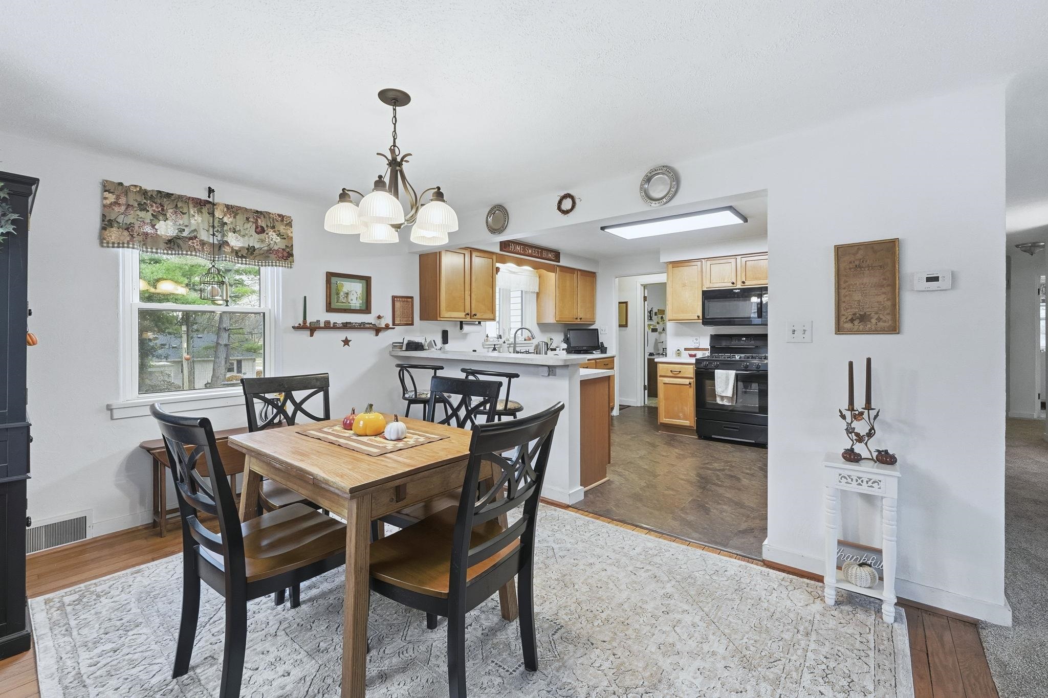 Dining area with light wood-style floors and a chandelier