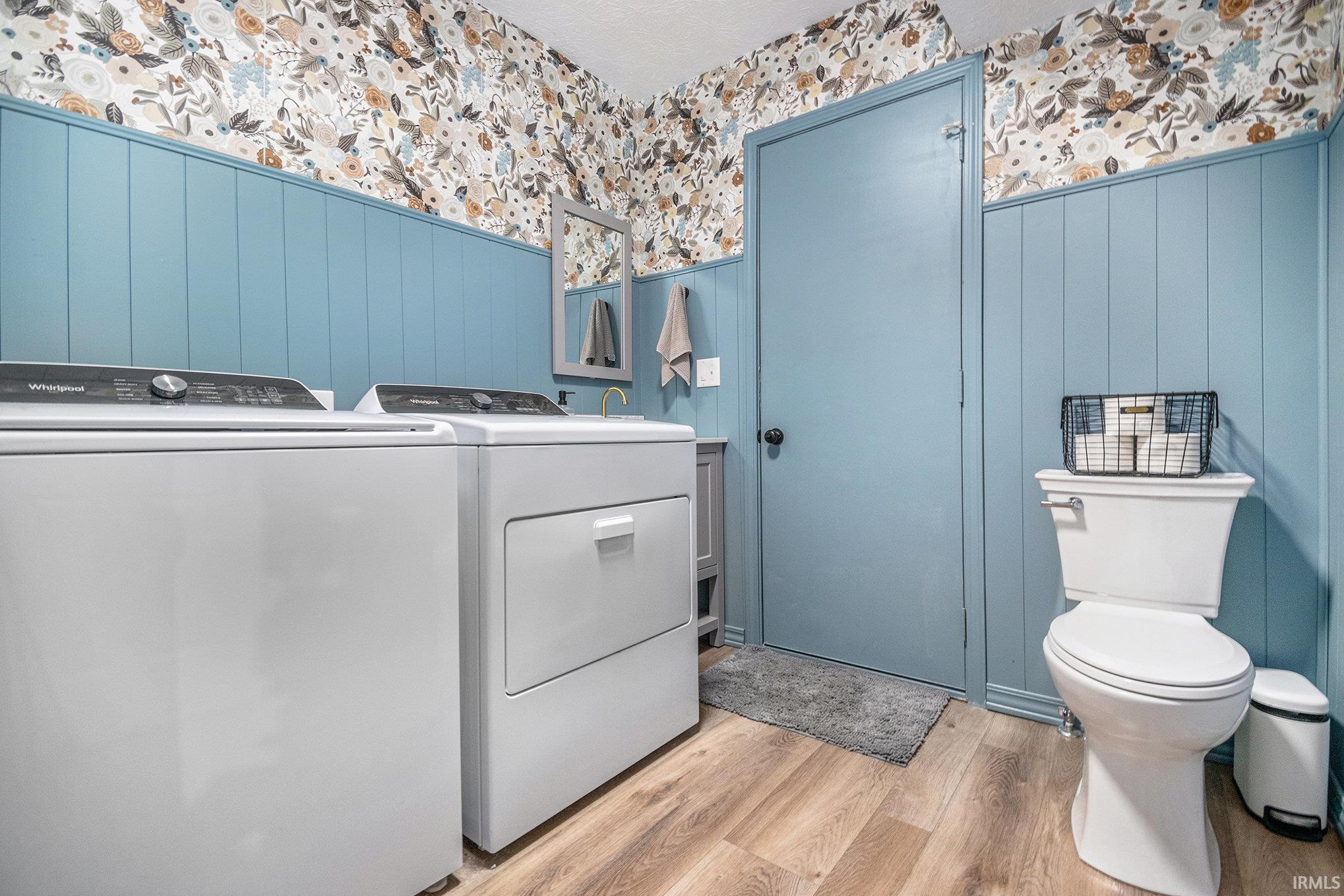 Bathroom with light wood-style floors, independent washer and dryer, and vanity