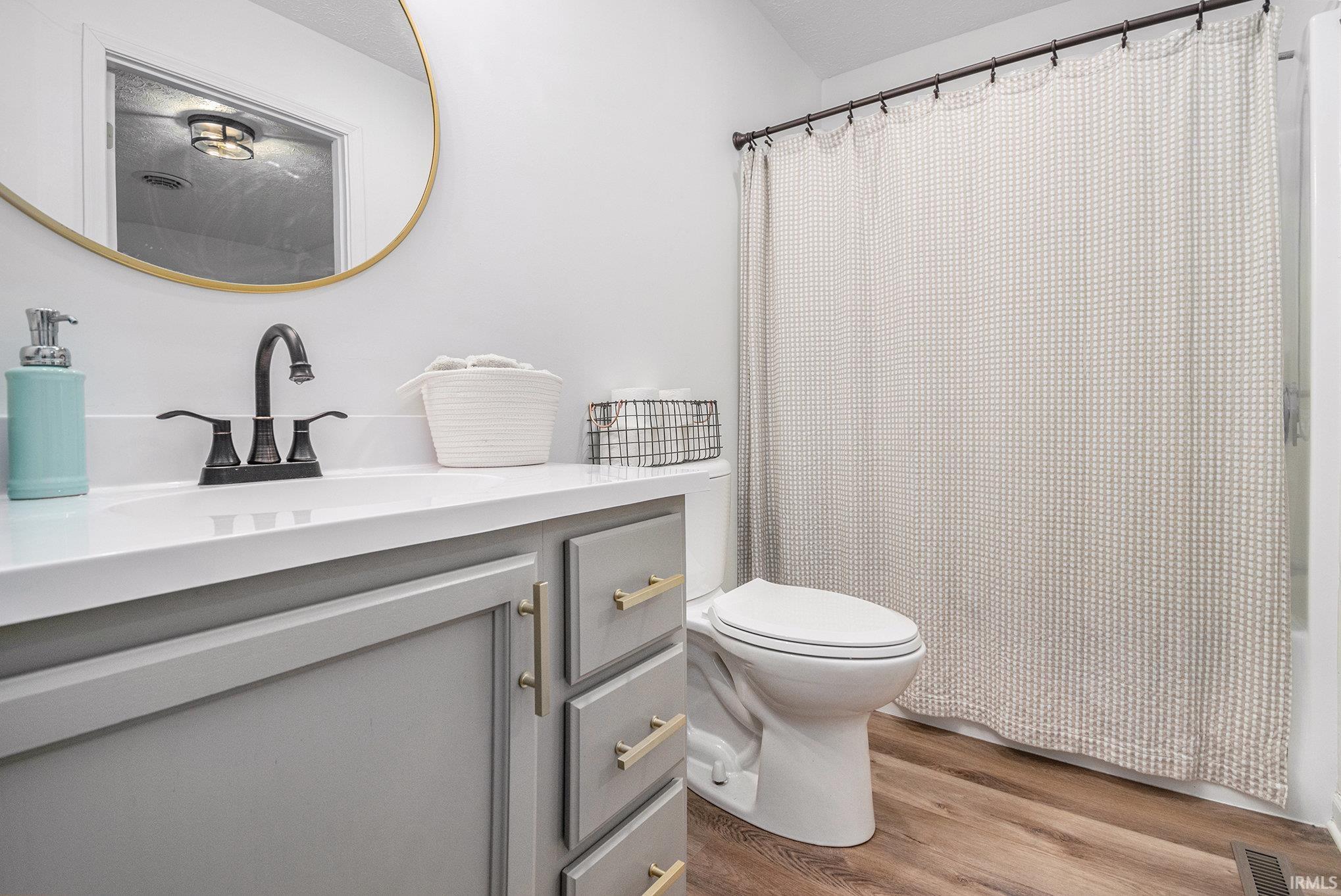 Bathroom with vanity and dark wood finished floors