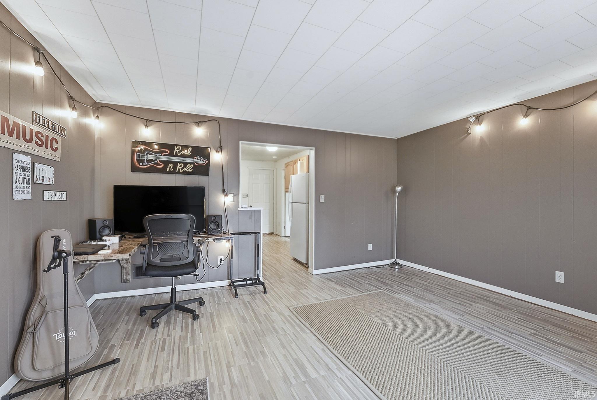 Office featuring wood finished floors and baseboards