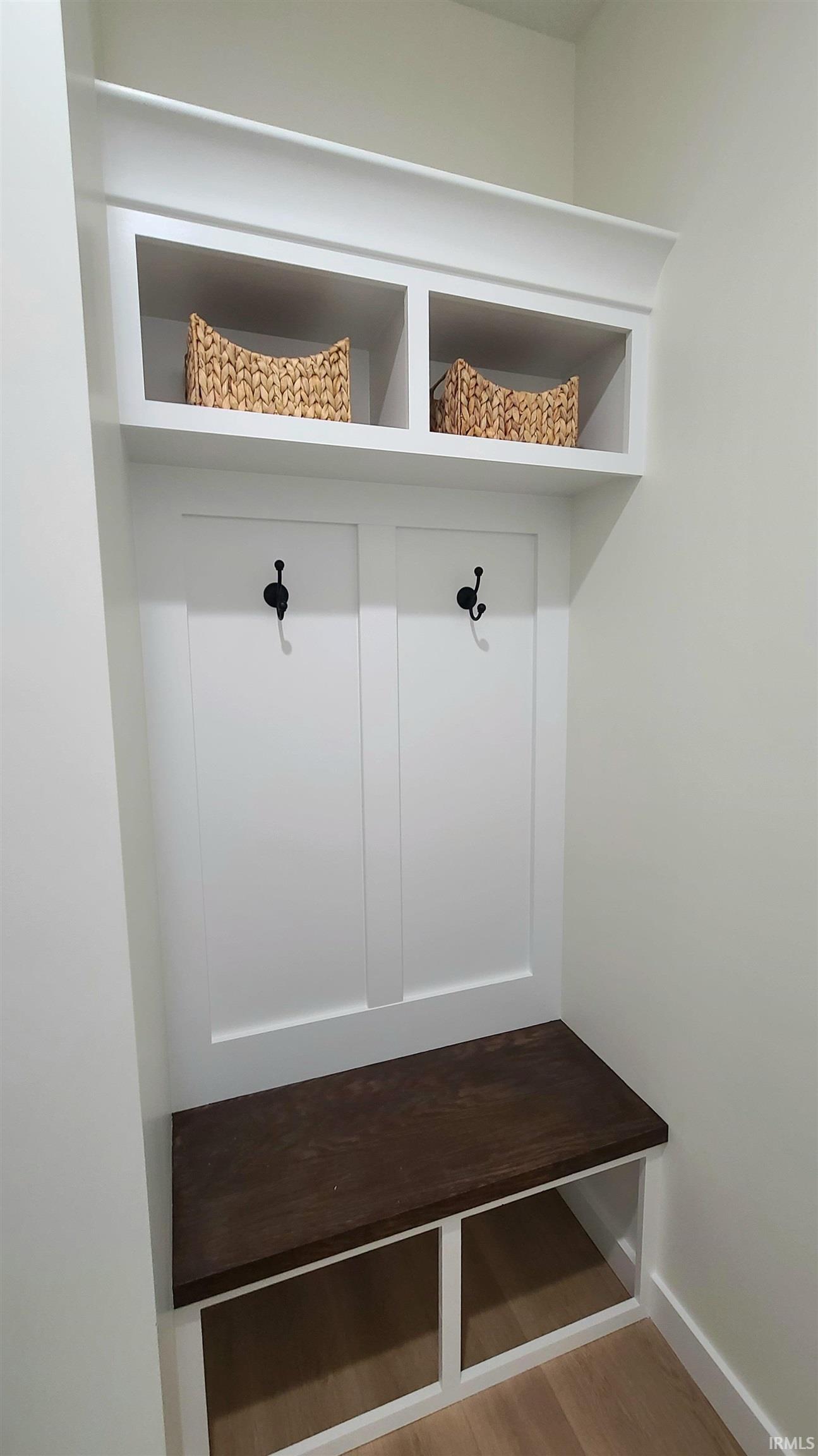 Mudroom featuring light wood-type flooring and baseboards
