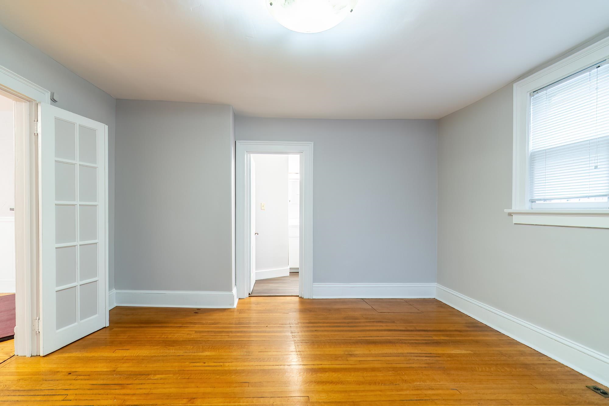 Unfurnished room with light wood finished floors and baseboards
