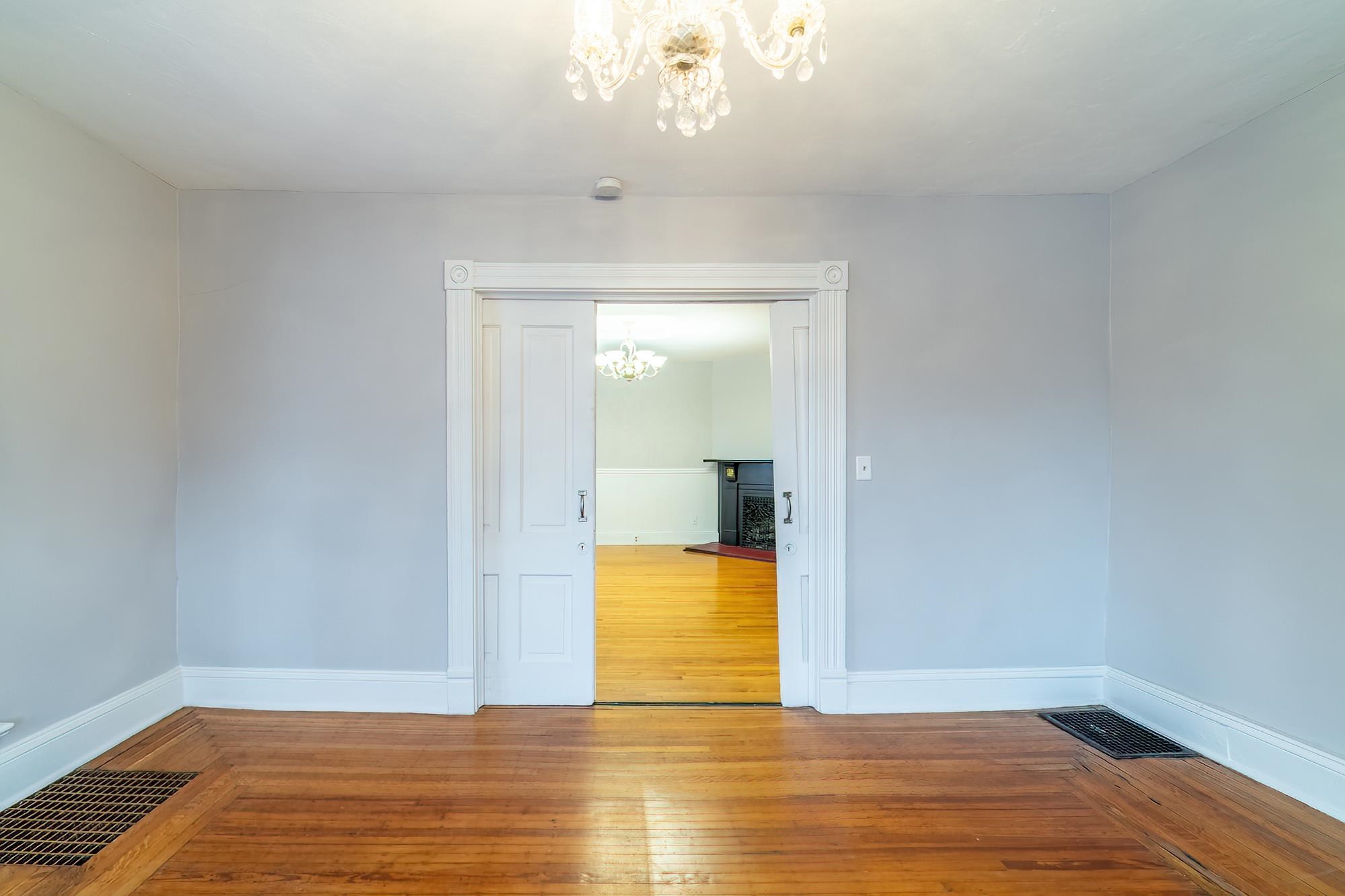Spare room with a chandelier and hardwood / wood-style flooring