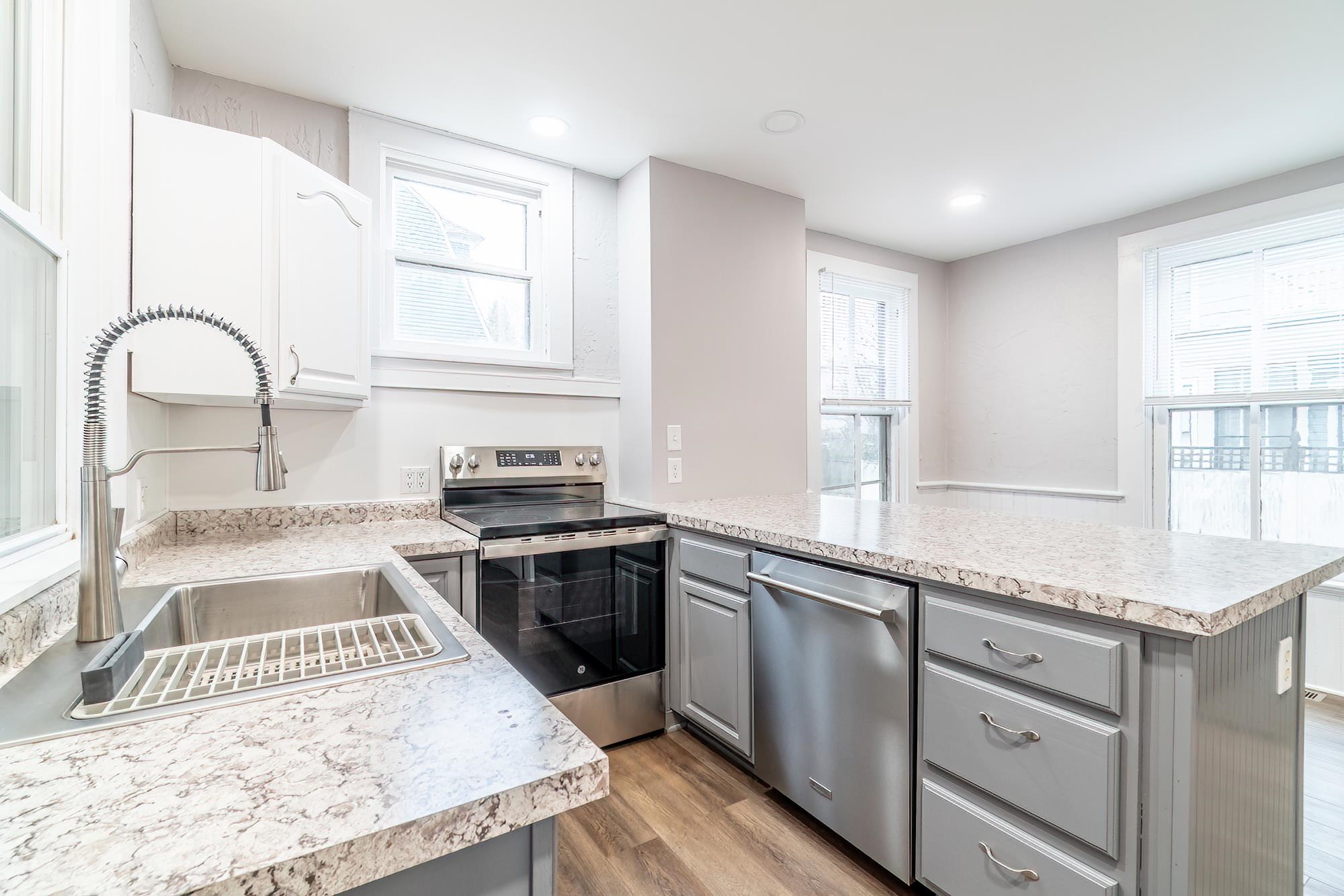 Kitchen with stainless steel appliances, light countertops, plenty of natural light, light wood-style flooring, and recessed lighting