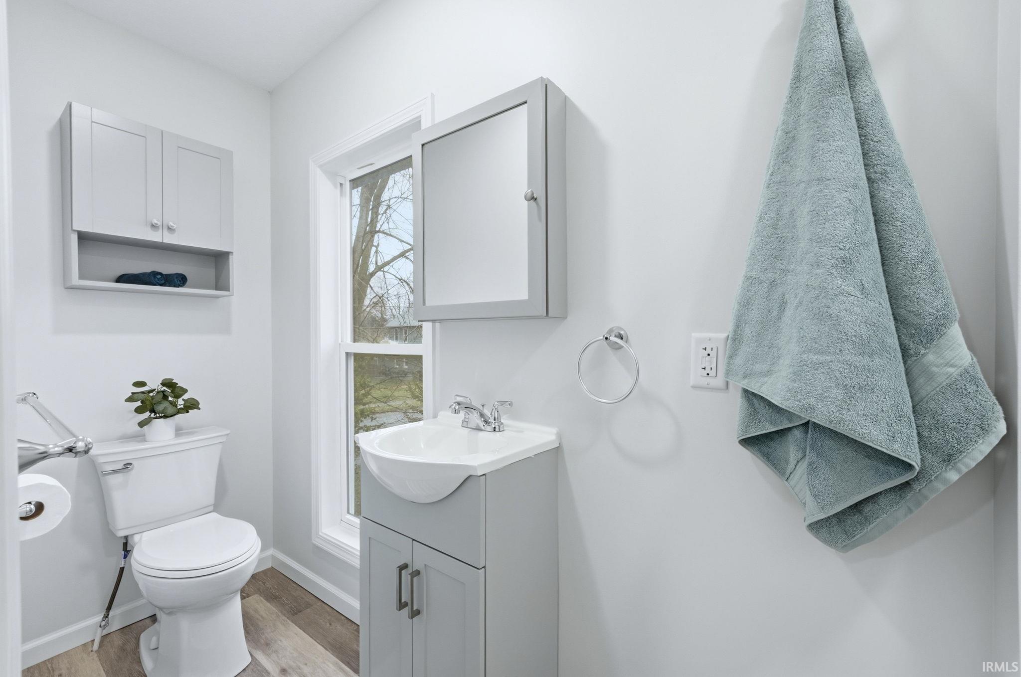 Half bath featuring vanity and light wood finished floors