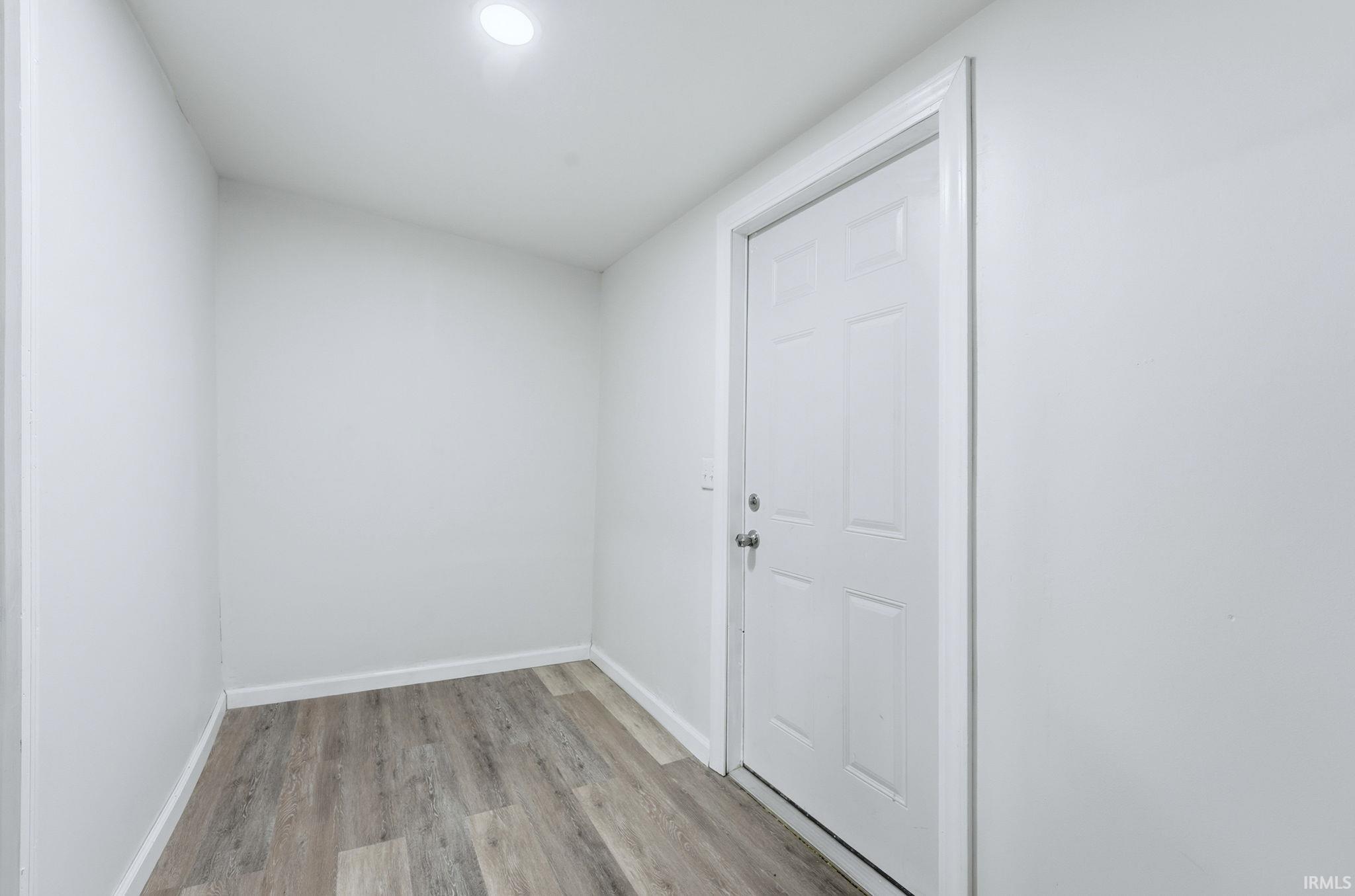 Doorway to outside featuring wood finished floors and recessed lighting
